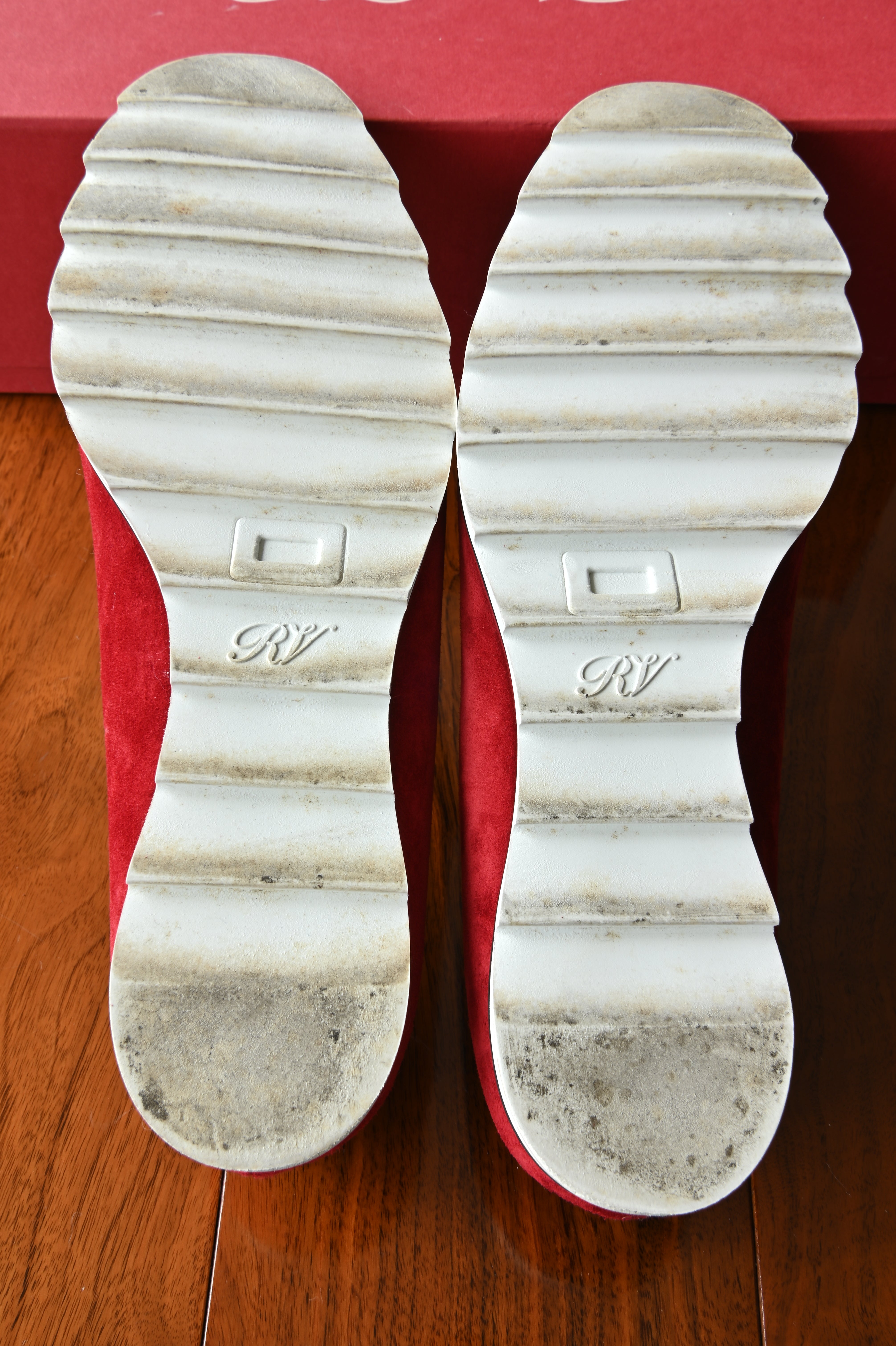 Bottom view of authentic Roger Vivier Gommettine ballet flats showing light wear on the white rubber outsoles consistent with careful use.