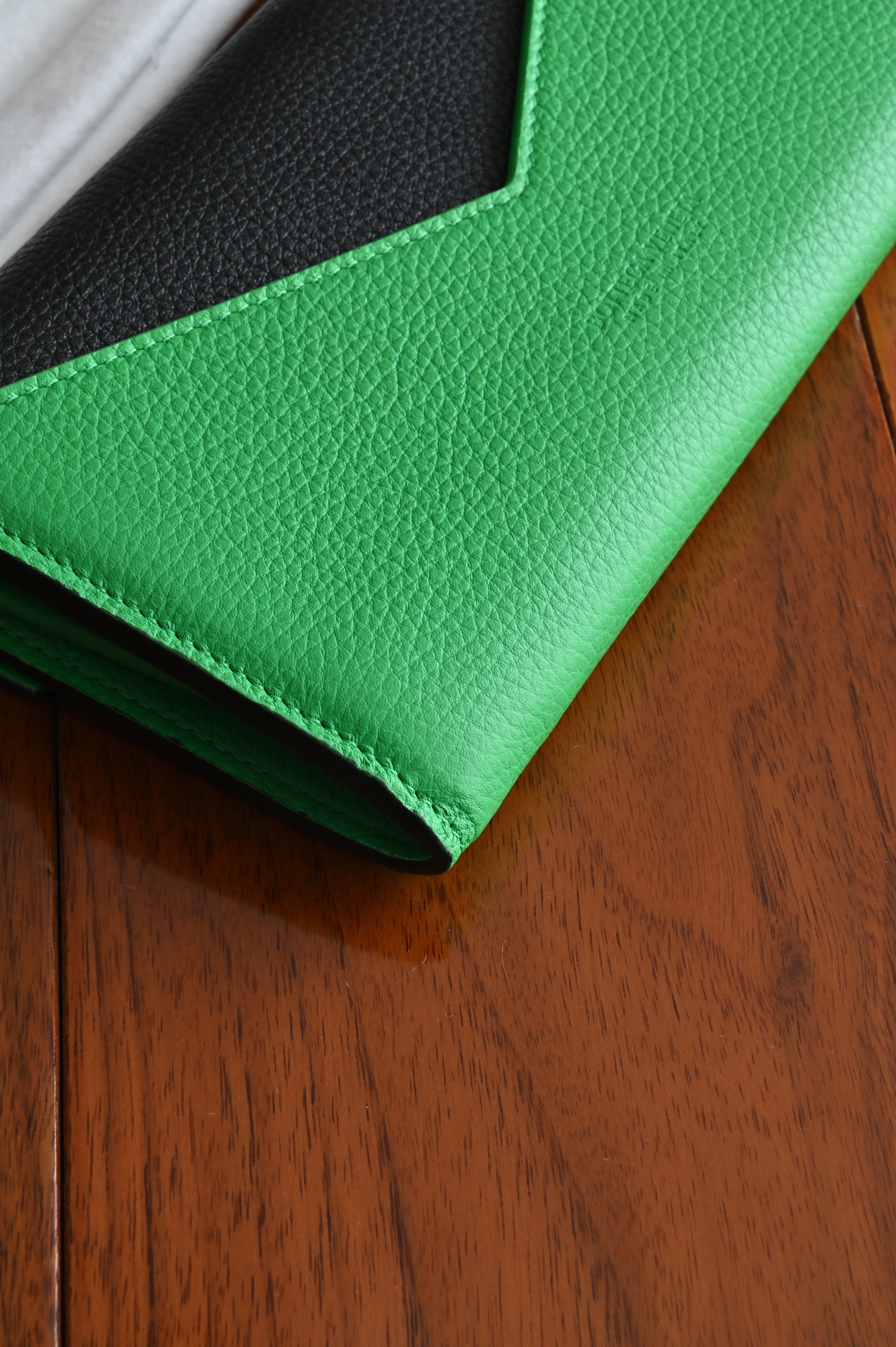 Bottega Veneta long envelope wallet in black and parakeet green back corner