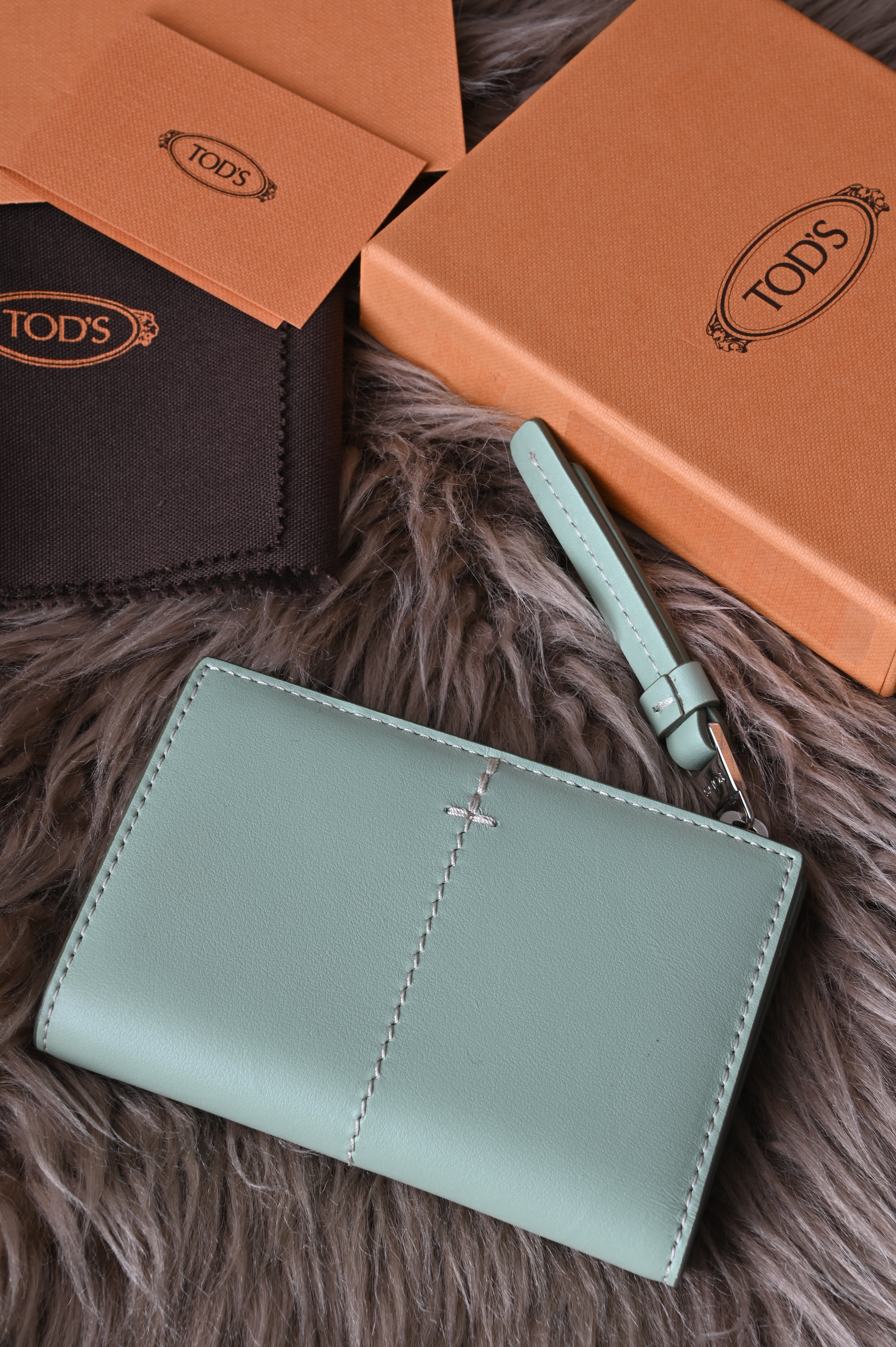 Tod's Flap compact wallet in teal green
