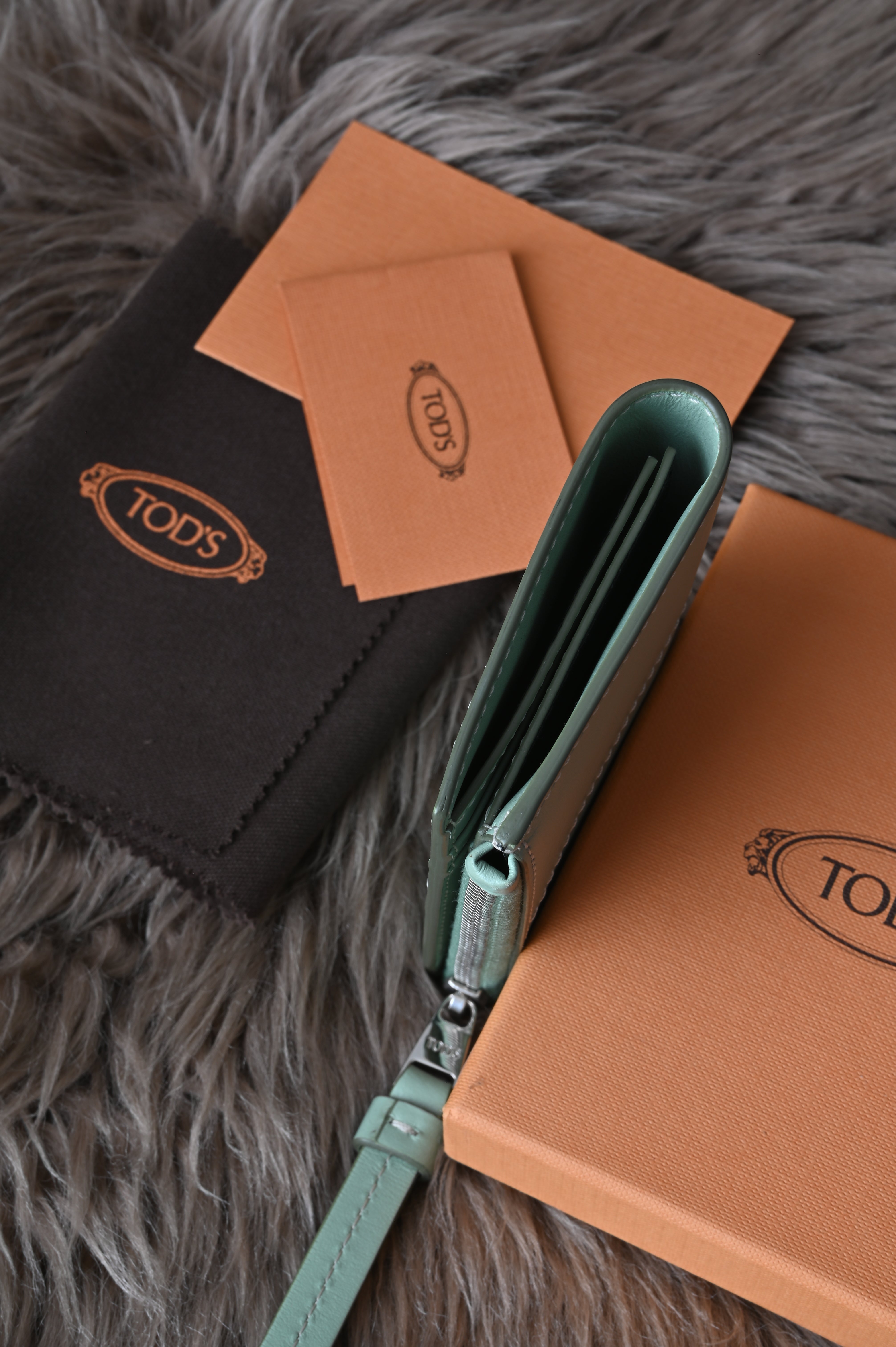 Tod's Flap compact wallet in teal green