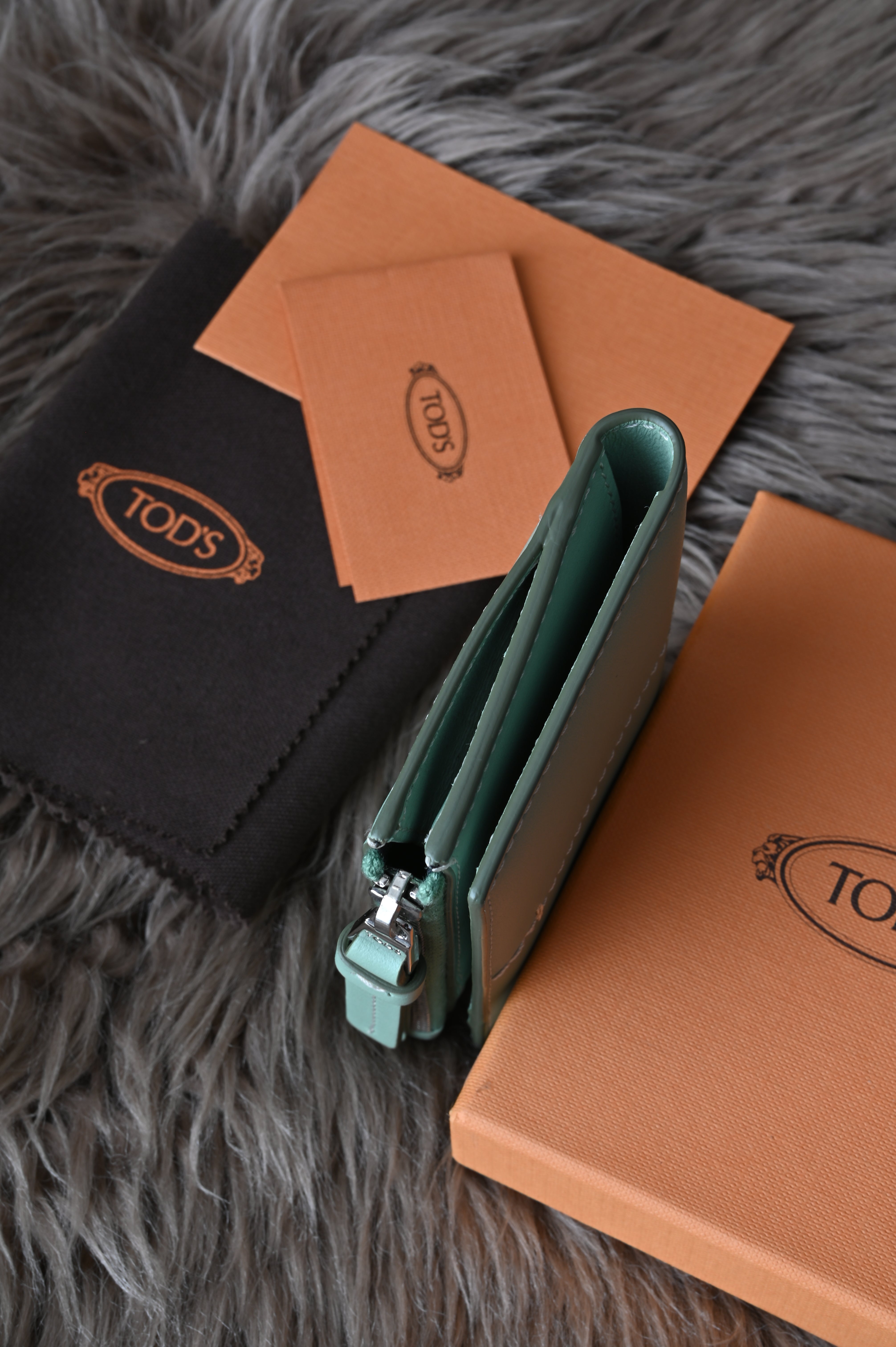 Tod's Flap compact wallet in teal green