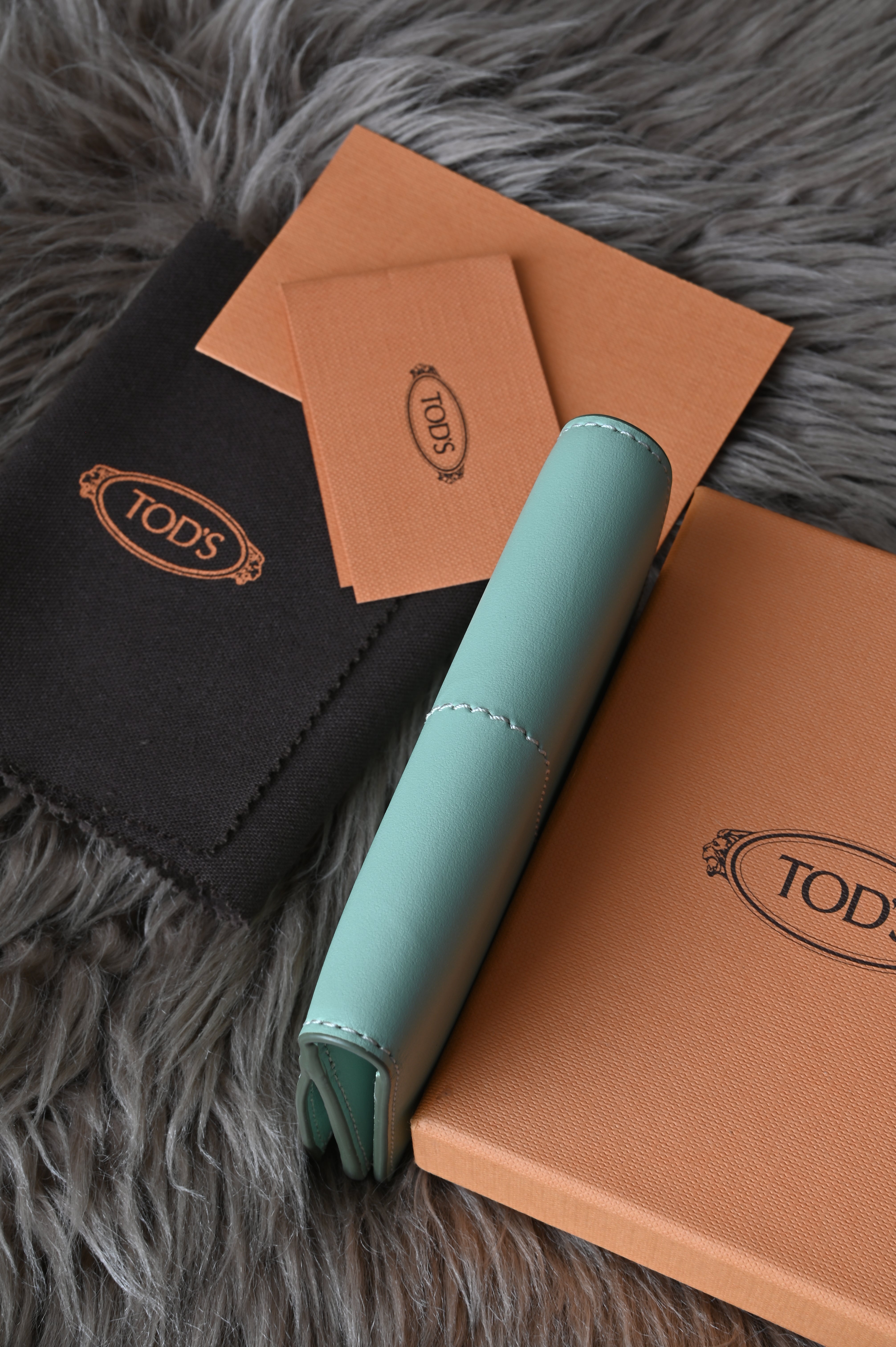 Tod's Flap compact wallet in teal green