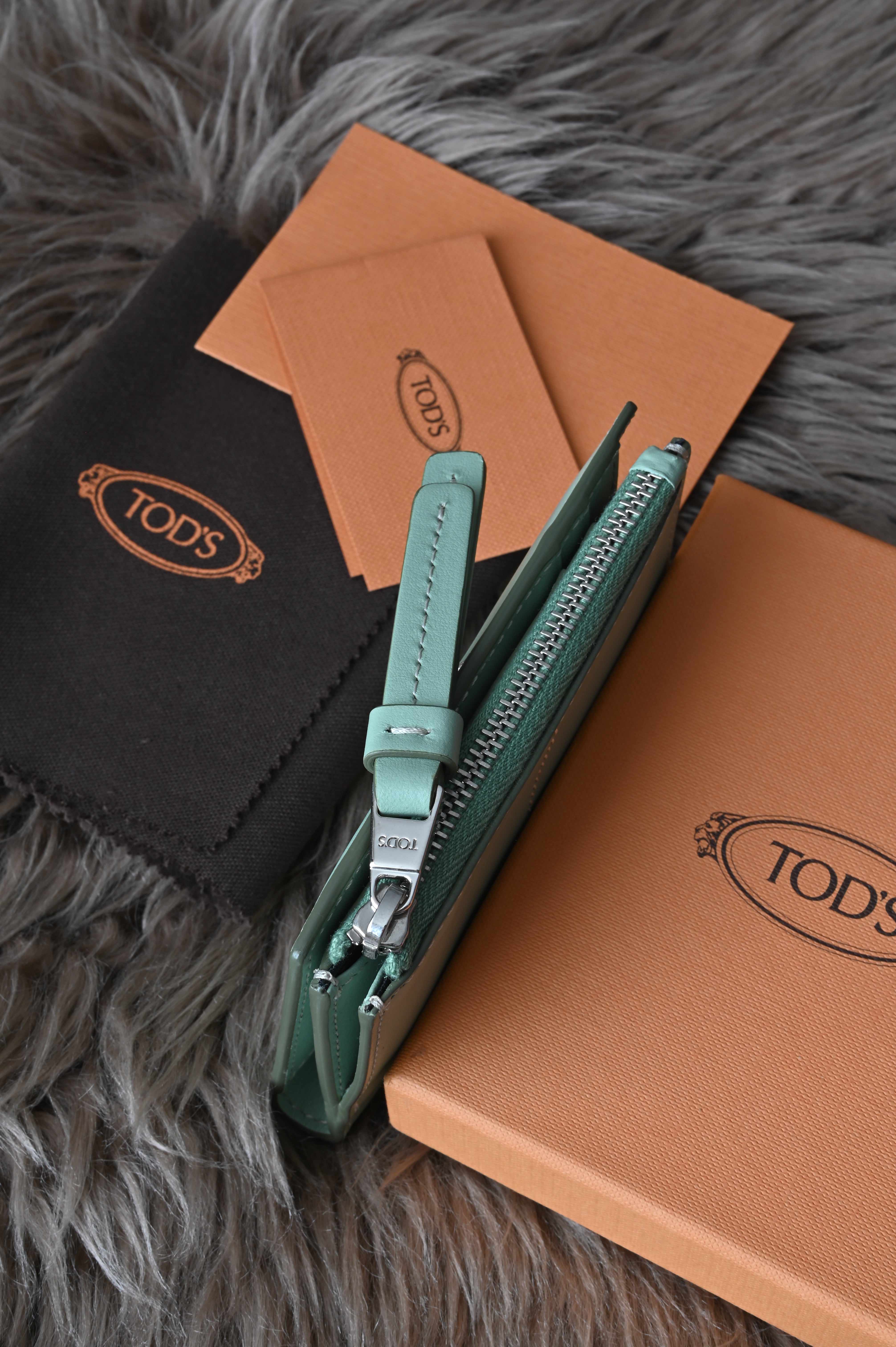 Tod's Flap compact wallet in teal green