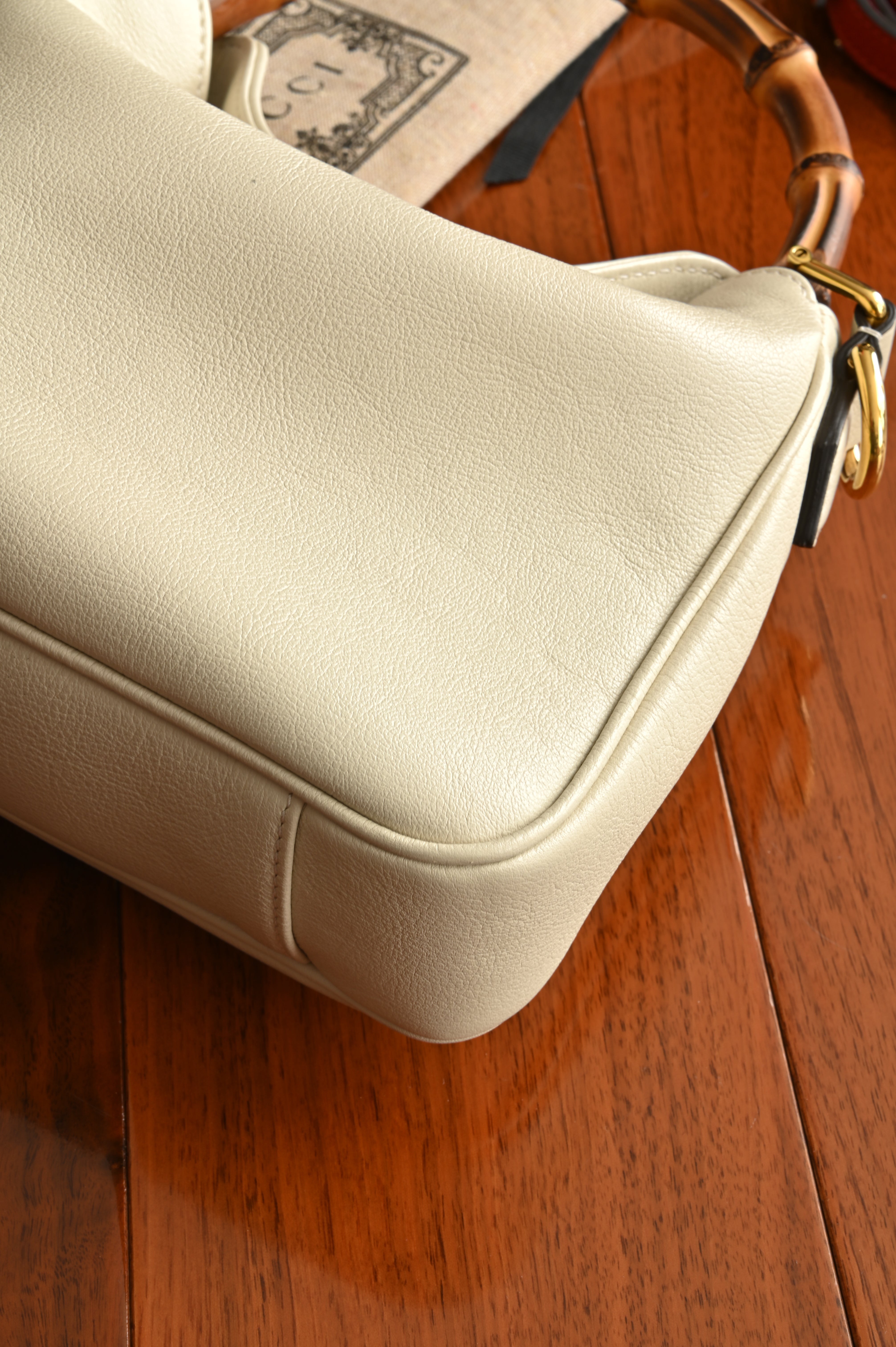 Gucci Diana Small Shoulder bag in White leather with bamboo top handles and gold-toned Double G hardware angle two