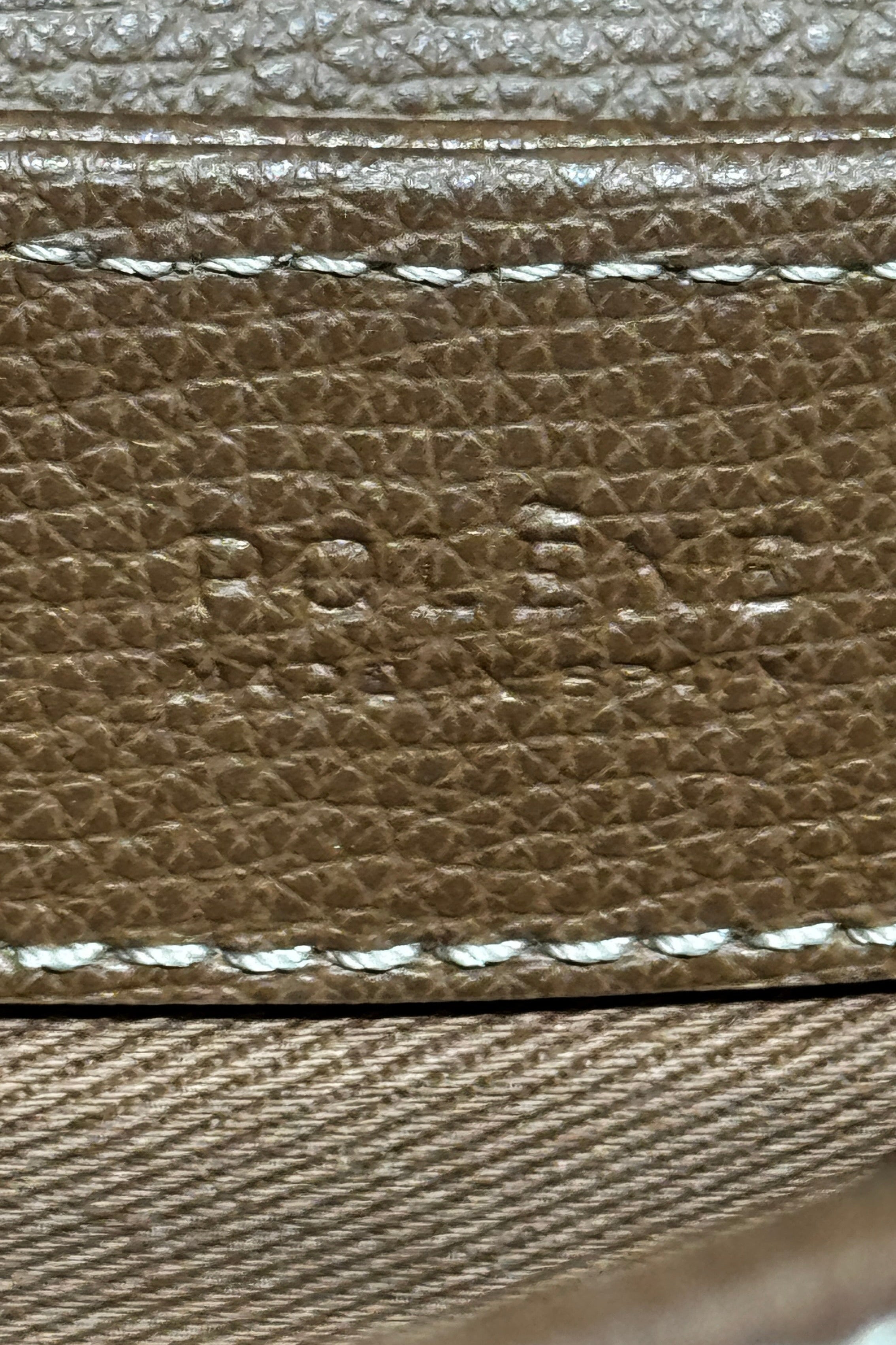 Authentic preloved Polène Numéro Un Nano Bag in Trio Camel, close-up logo detail showcasing the embossed Polène branding and premium leather craftsmanship.