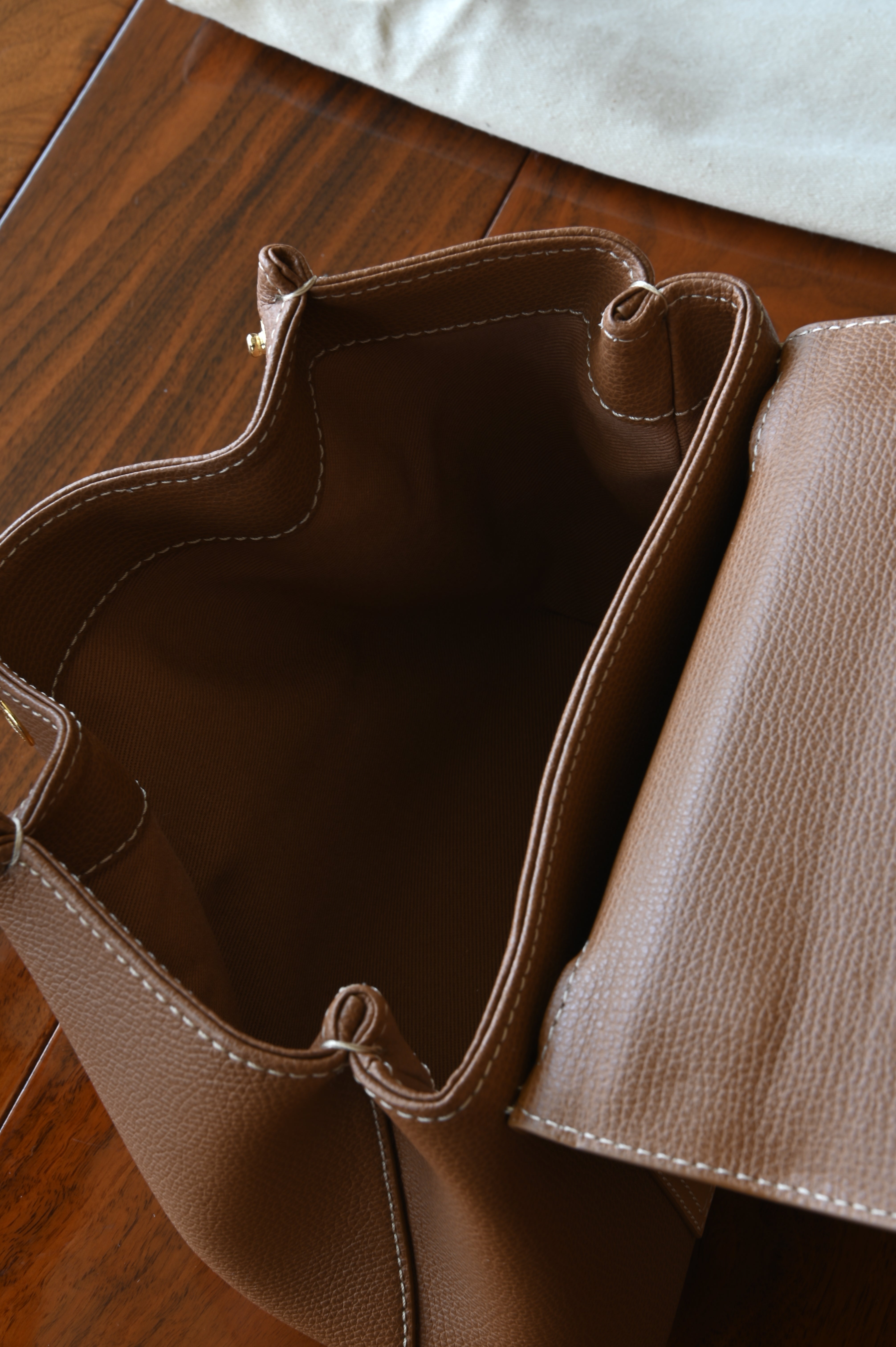Authentic preloved Polène Numéro Un Nano Bag in Trio Camel, interior view showcasing the leather-lined compartment and storage space.