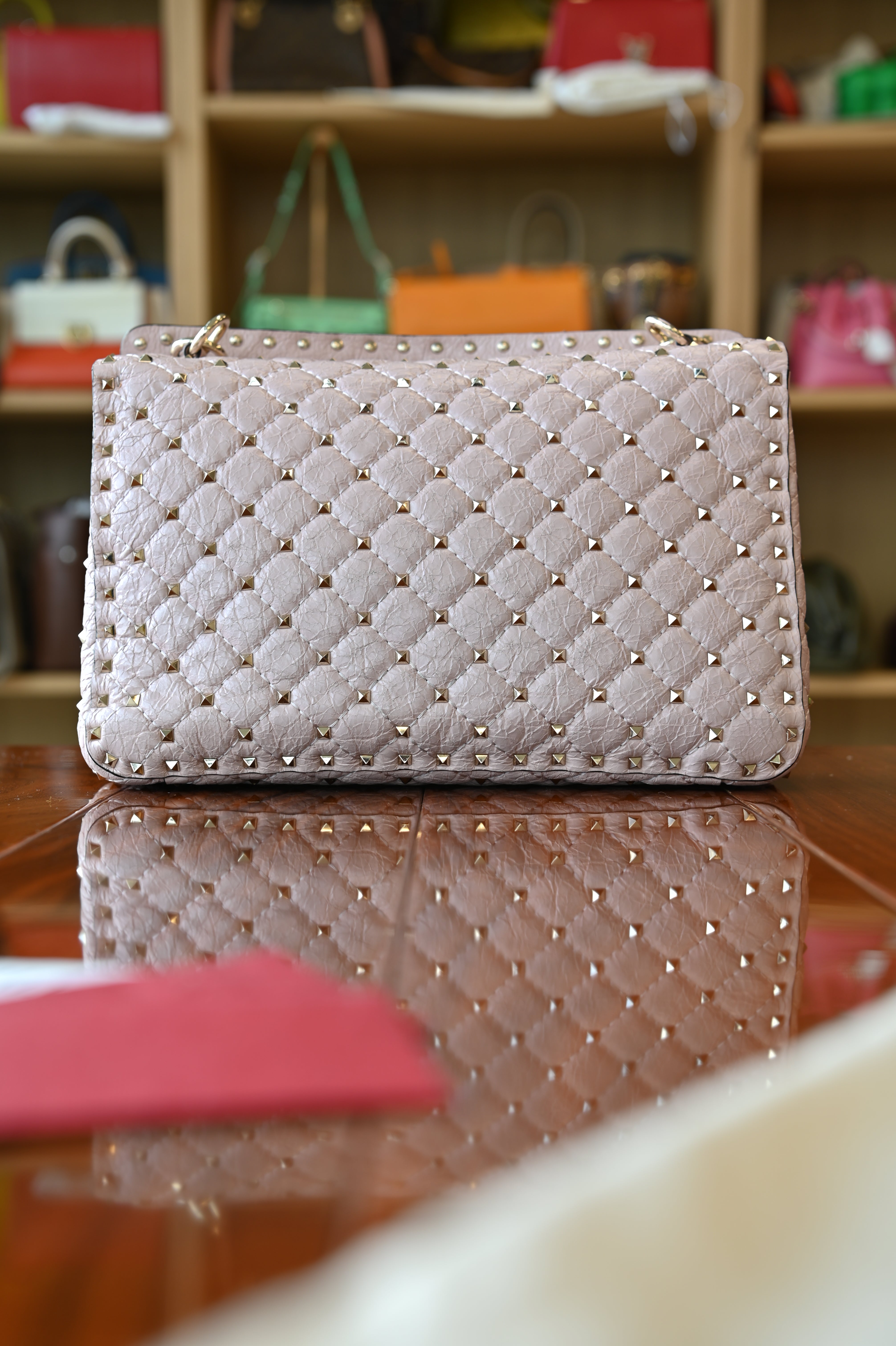 Preloved Valentino Garavani Pink Rockstud Shoulder Bag in blush pink leather featuring signature gold-tone Rockstud embellishments, structured silhouette, adjustable shoulder strap, and elegant luxury design