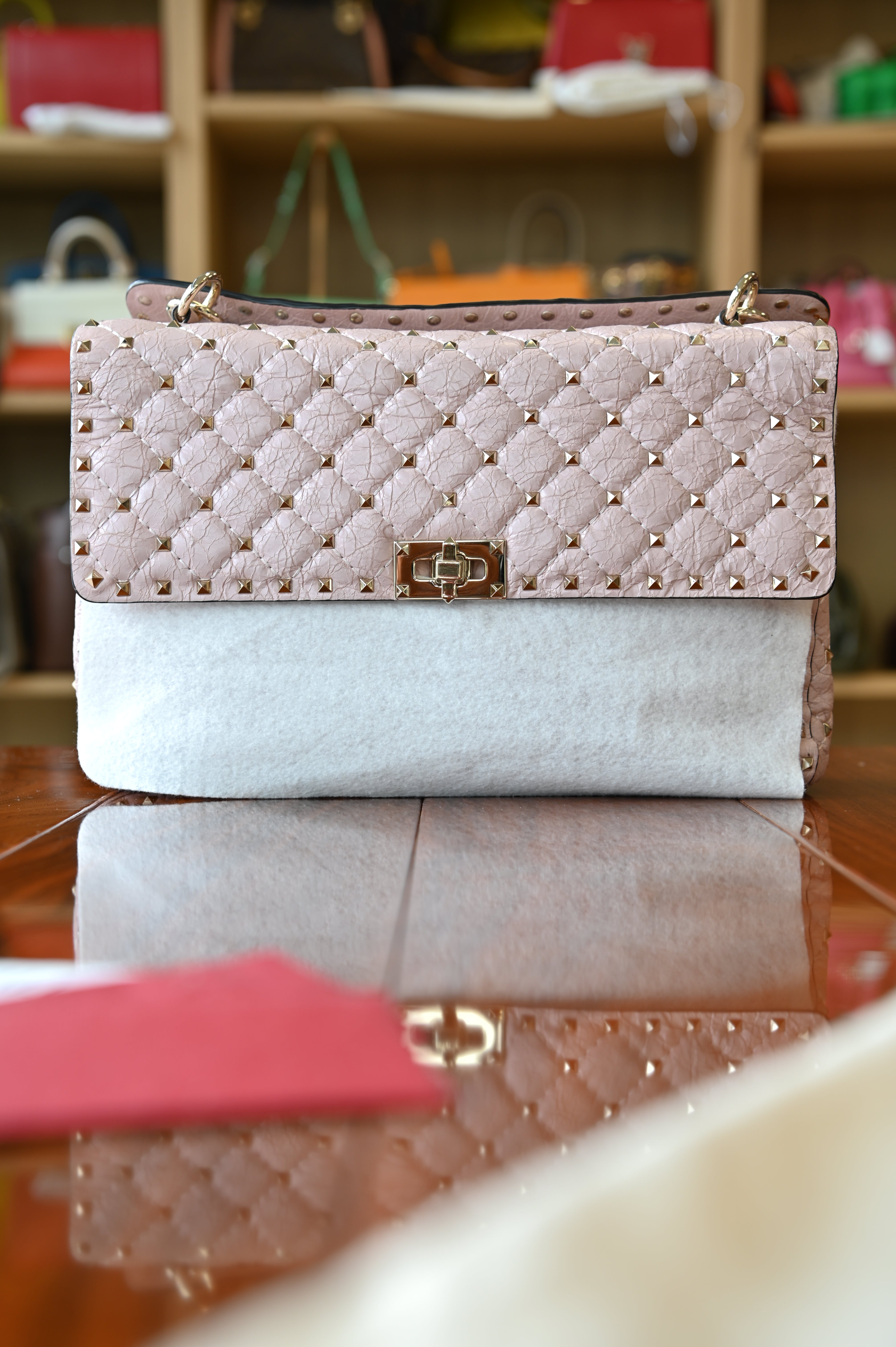 Preloved Valentino Garavani Pink Rockstud Shoulder Bag in blush pink leather featuring signature gold-tone Rockstud embellishments, structured silhouette, adjustable shoulder strap, and elegant luxury design