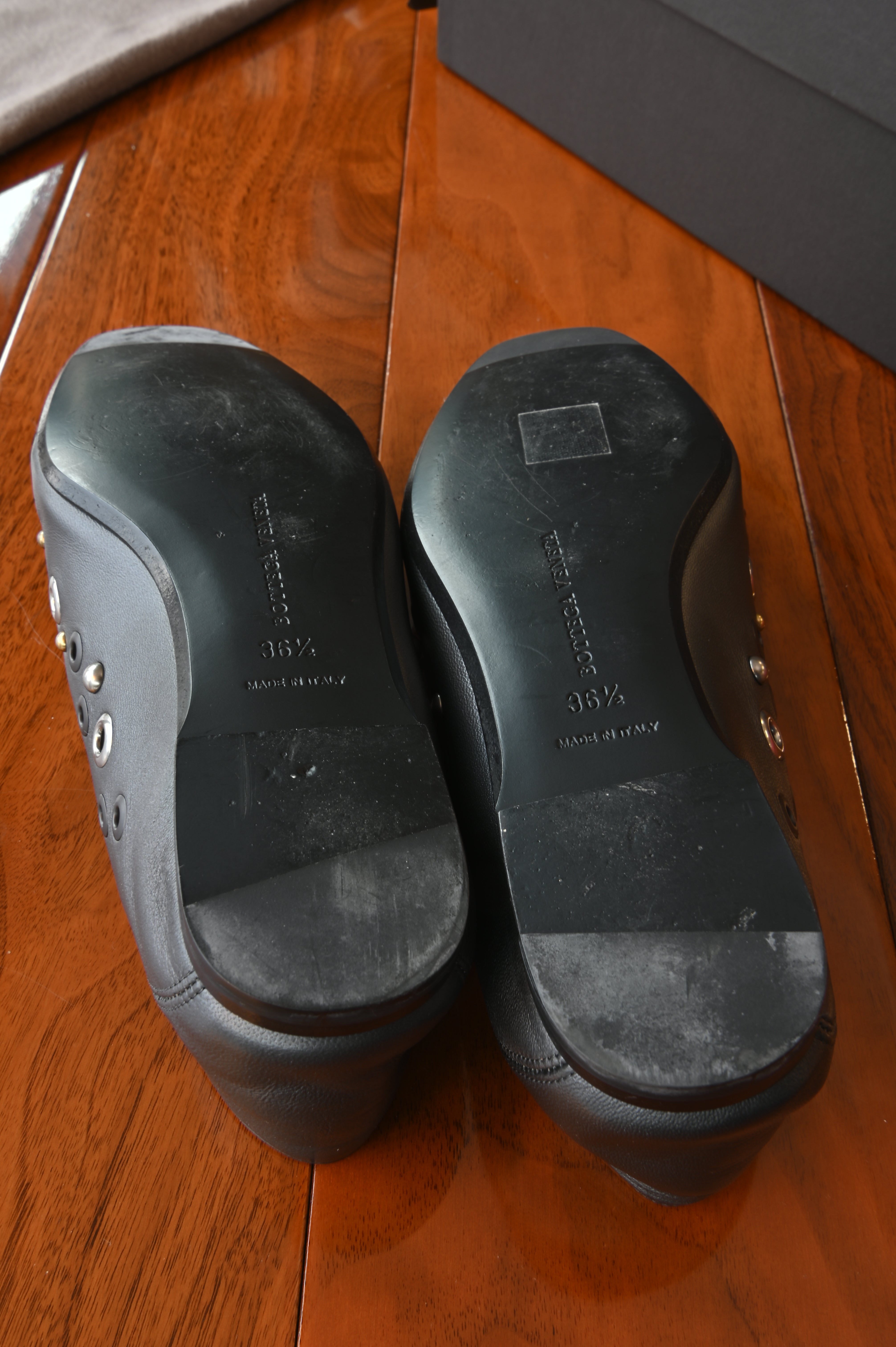 Authentic Bottega Veneta Black Intrecciato Eyelet Leather Loafers showing the leather outsoles with size markings and signs of light previous wear.