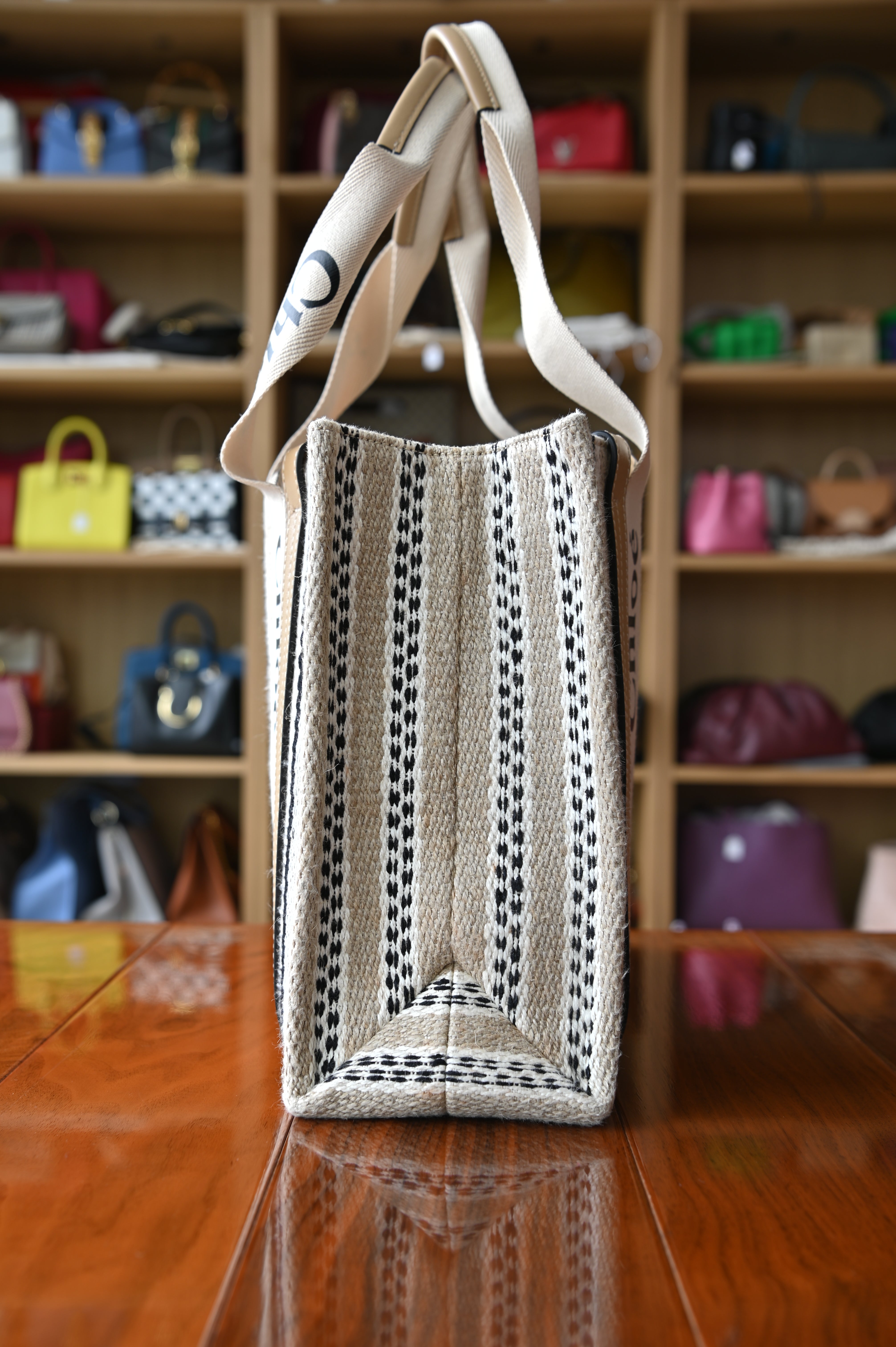 Authentic Chloé Woody Medium Striped Tote Bag showing the right side profile with structured silhouette and signature Chloé webbing.