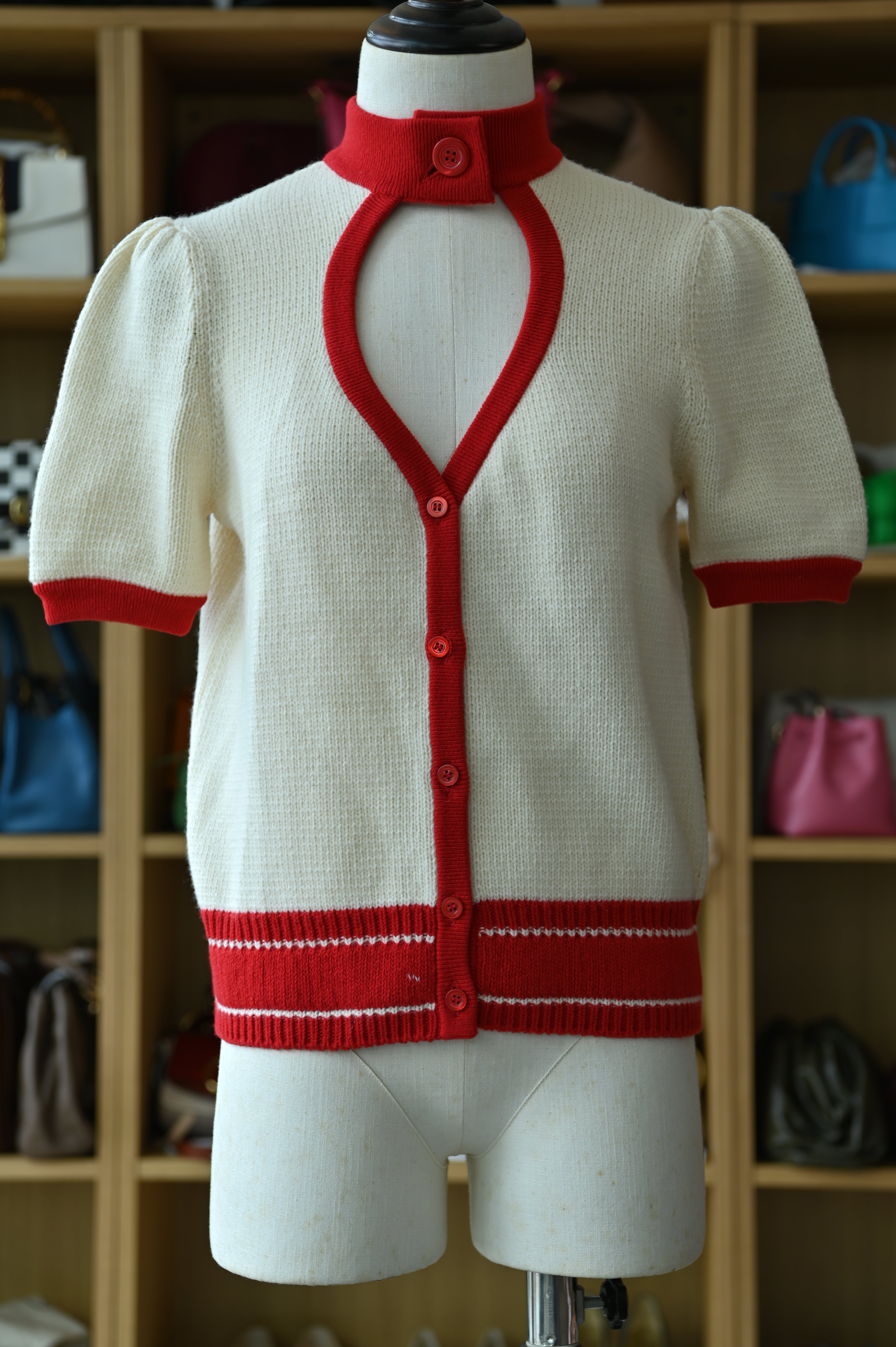 Authentic Christian Dior White & Red Knit Cardigan featuring contrast red trim, front button closure and short sleeves, front view.