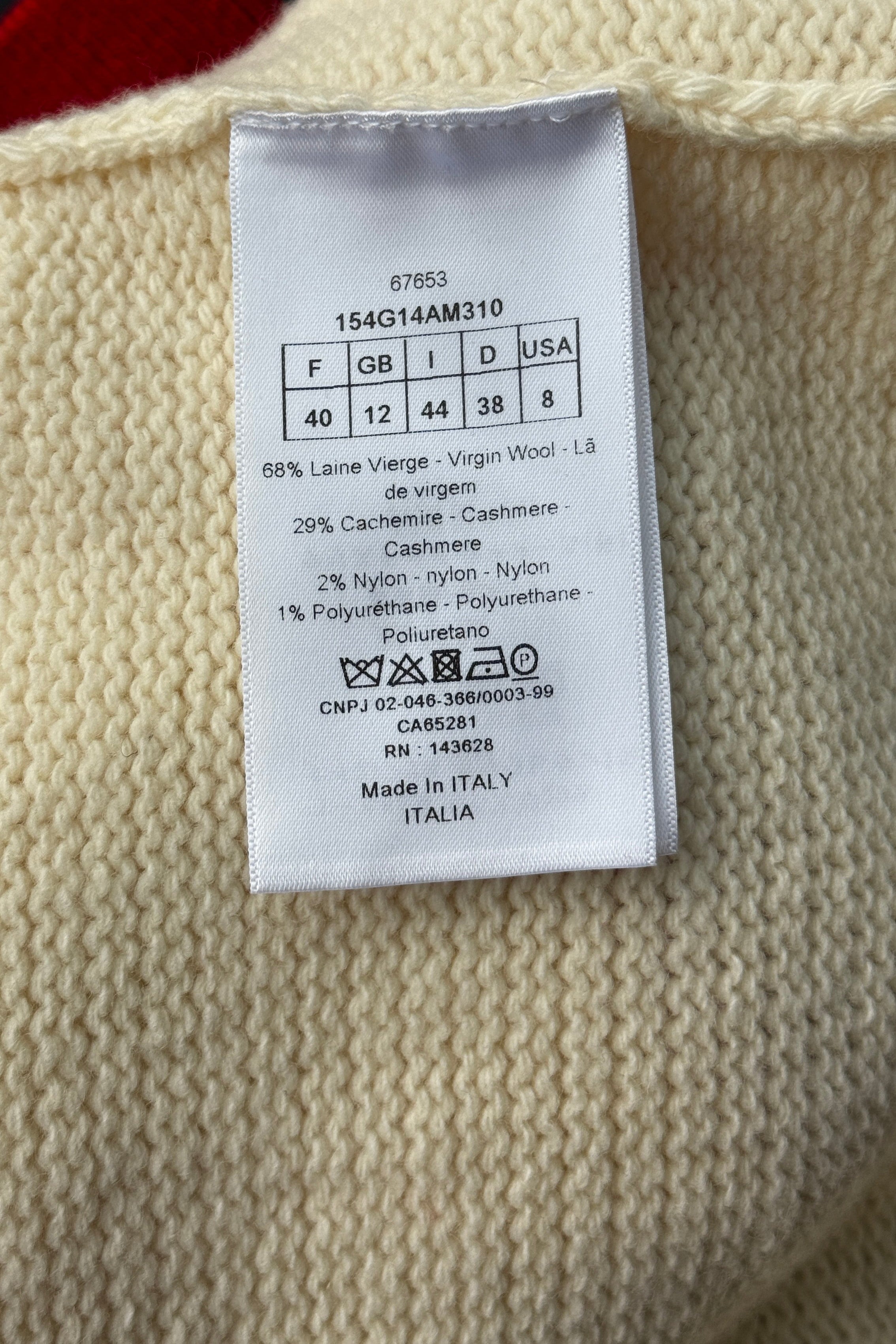 Close-up of the authentic Christian Dior material tag showing the composition of 68% virgin wool, 29% cashmere, 2% nylon and 1% polyurethane, made in Italy.