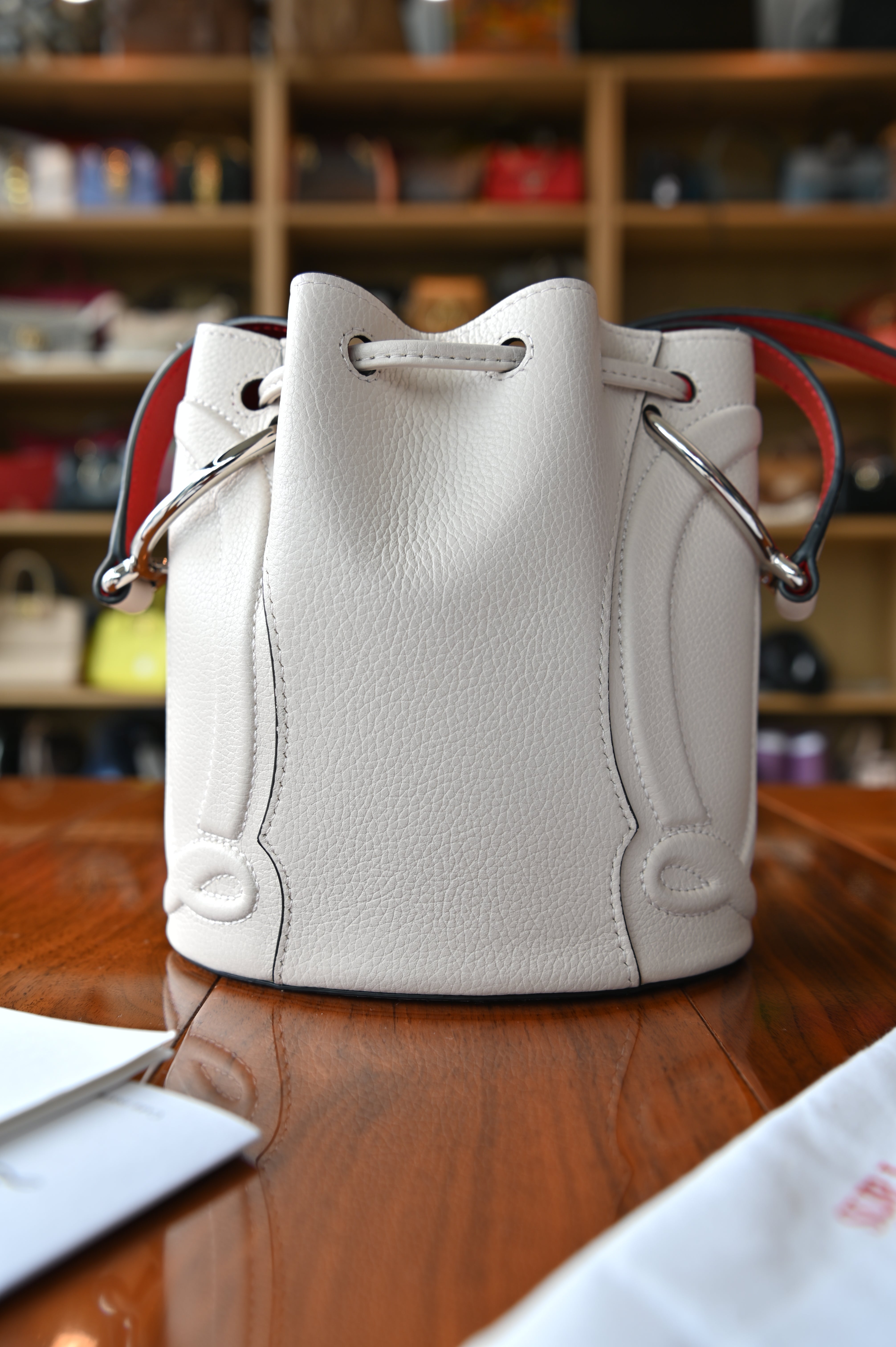 Authentic Christian Louboutin By My Side Light Pink Leather Bucket Bag shown from the back.