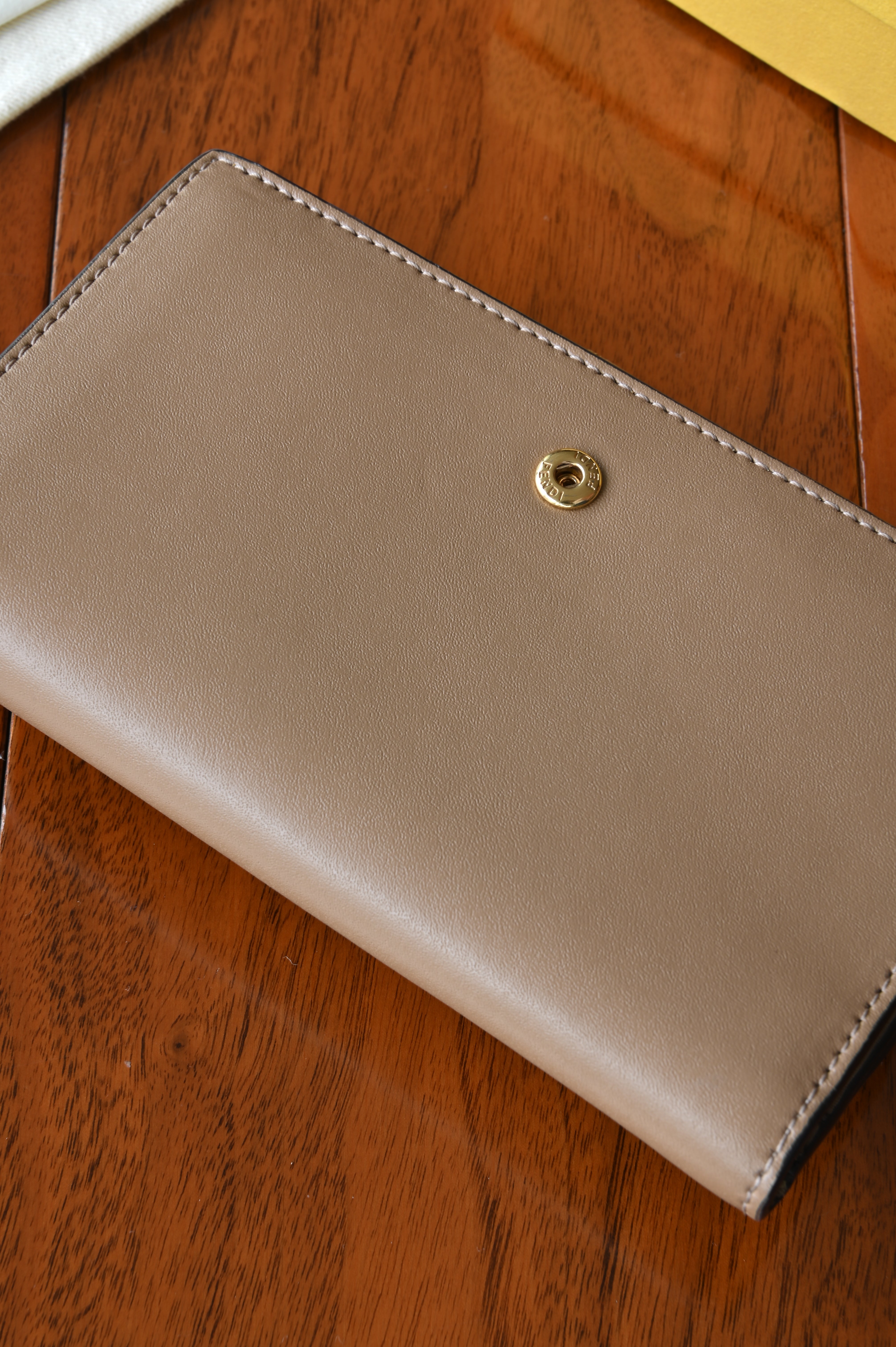 Detailed rear view of the authentic Fendi beige leather continental wallet highlighting the smooth leather finish.