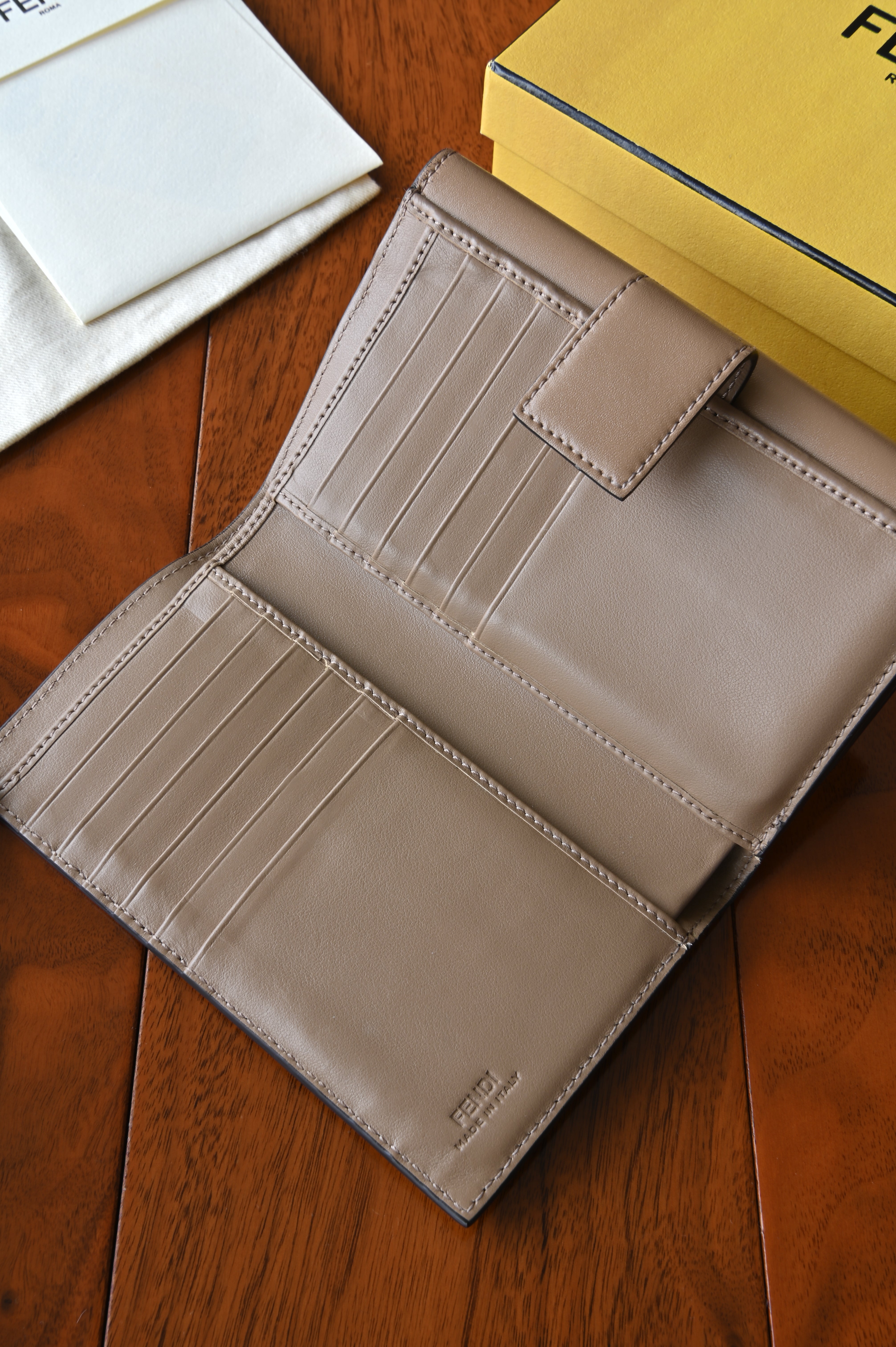 Close-up of the interior card slots and compartments of the authentic Fendi beige leather continental wallet.