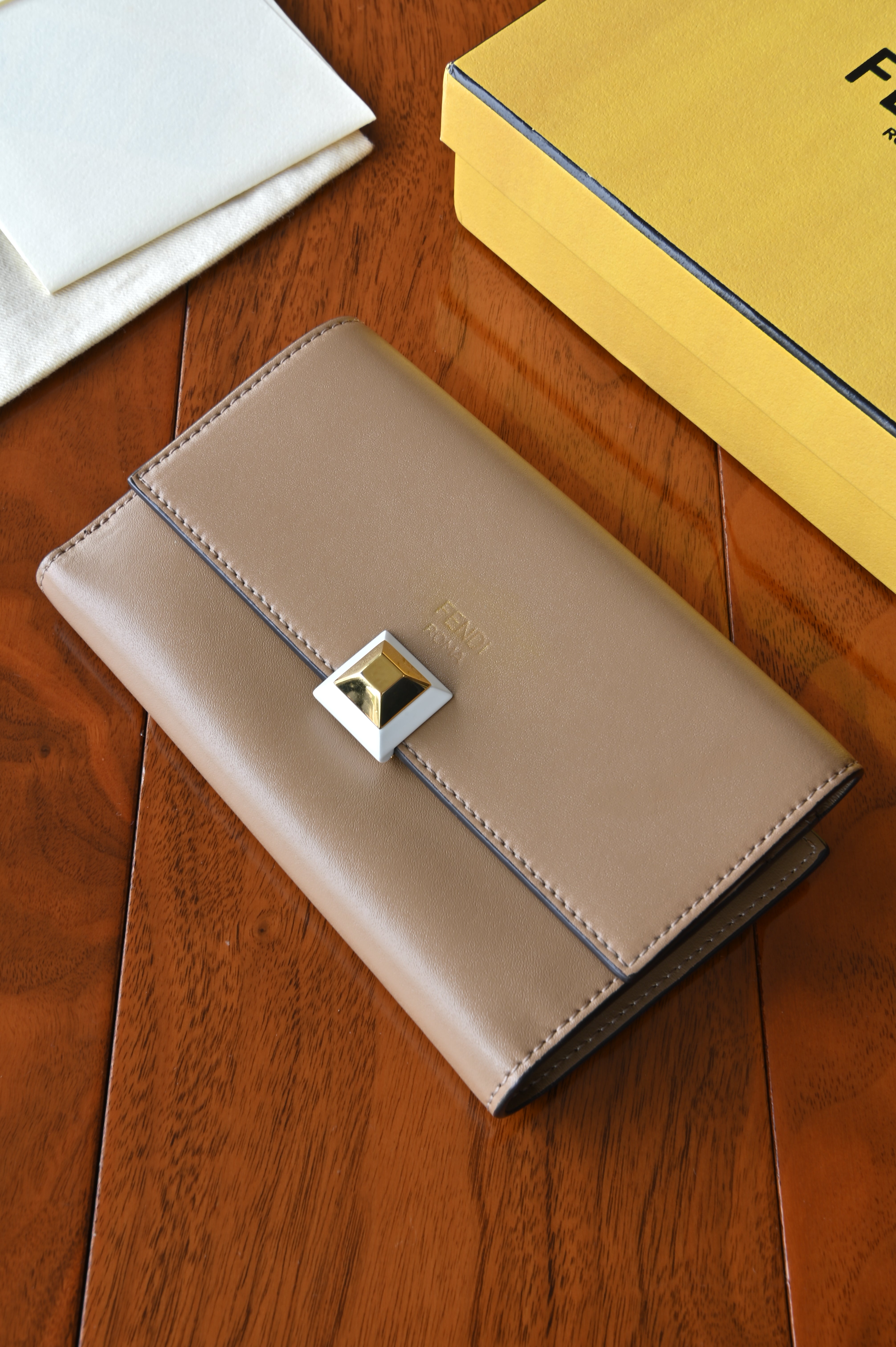 Authentic Fendi beige leather continental wallet featuring the signature pyramid push-lock closure and smooth leather exterior.
