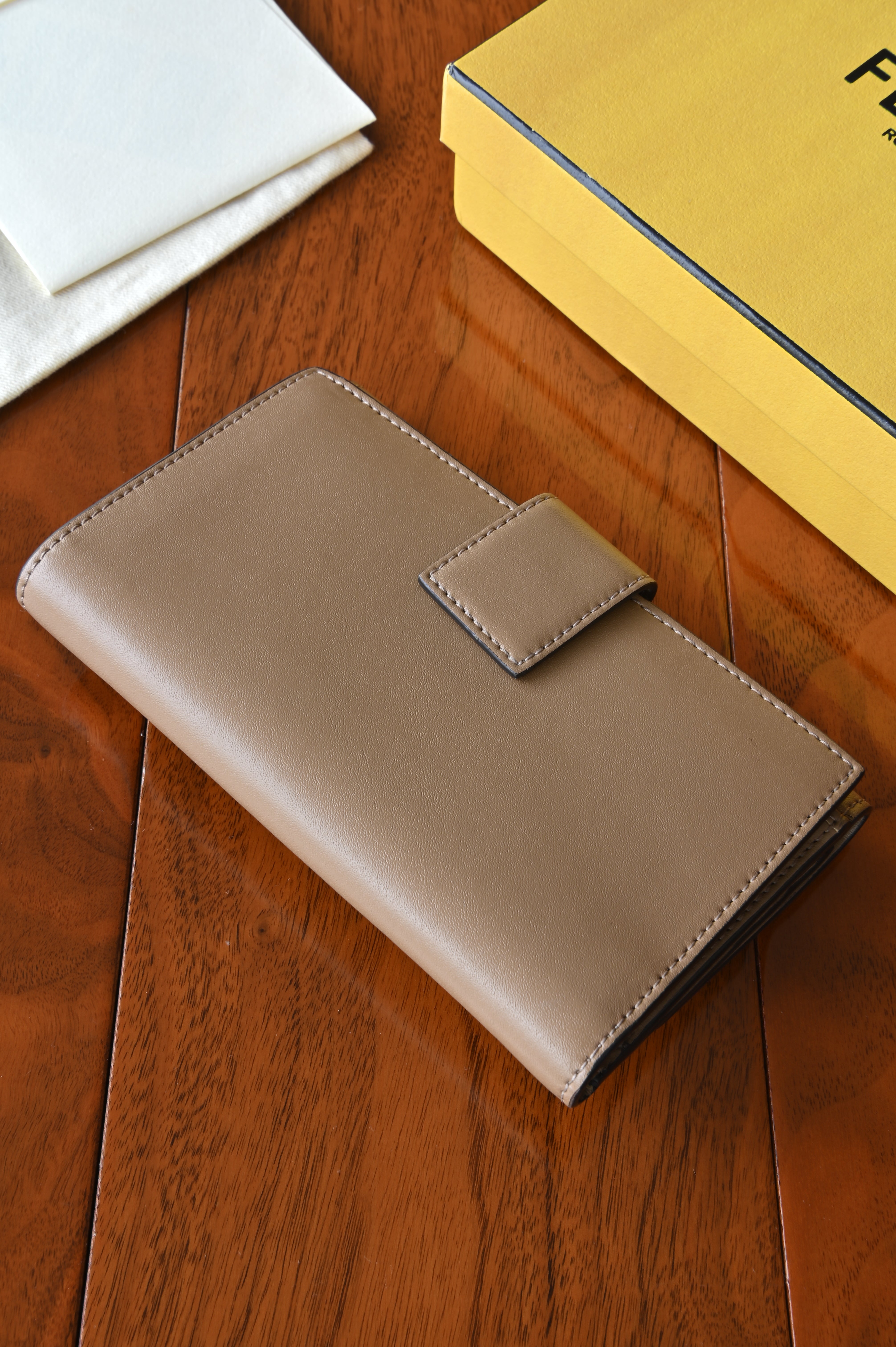 Rear view of the authentic Fendi beige leather continental wallet showcasing the clean leather exterior.