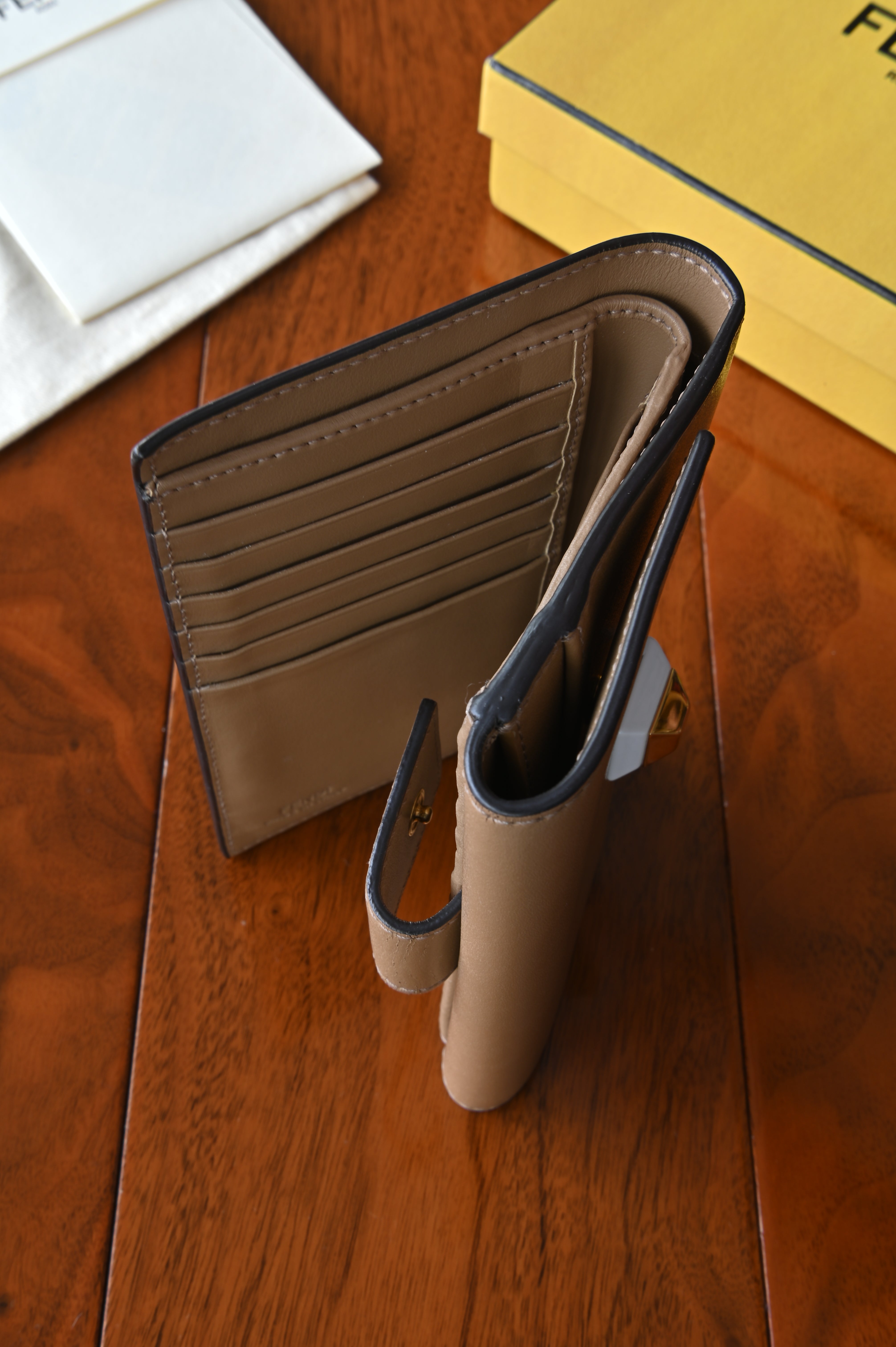 Top view of the authentic Fendi beige leather continental wallet showcasing the spacious interior compartments and leather-lined finish.