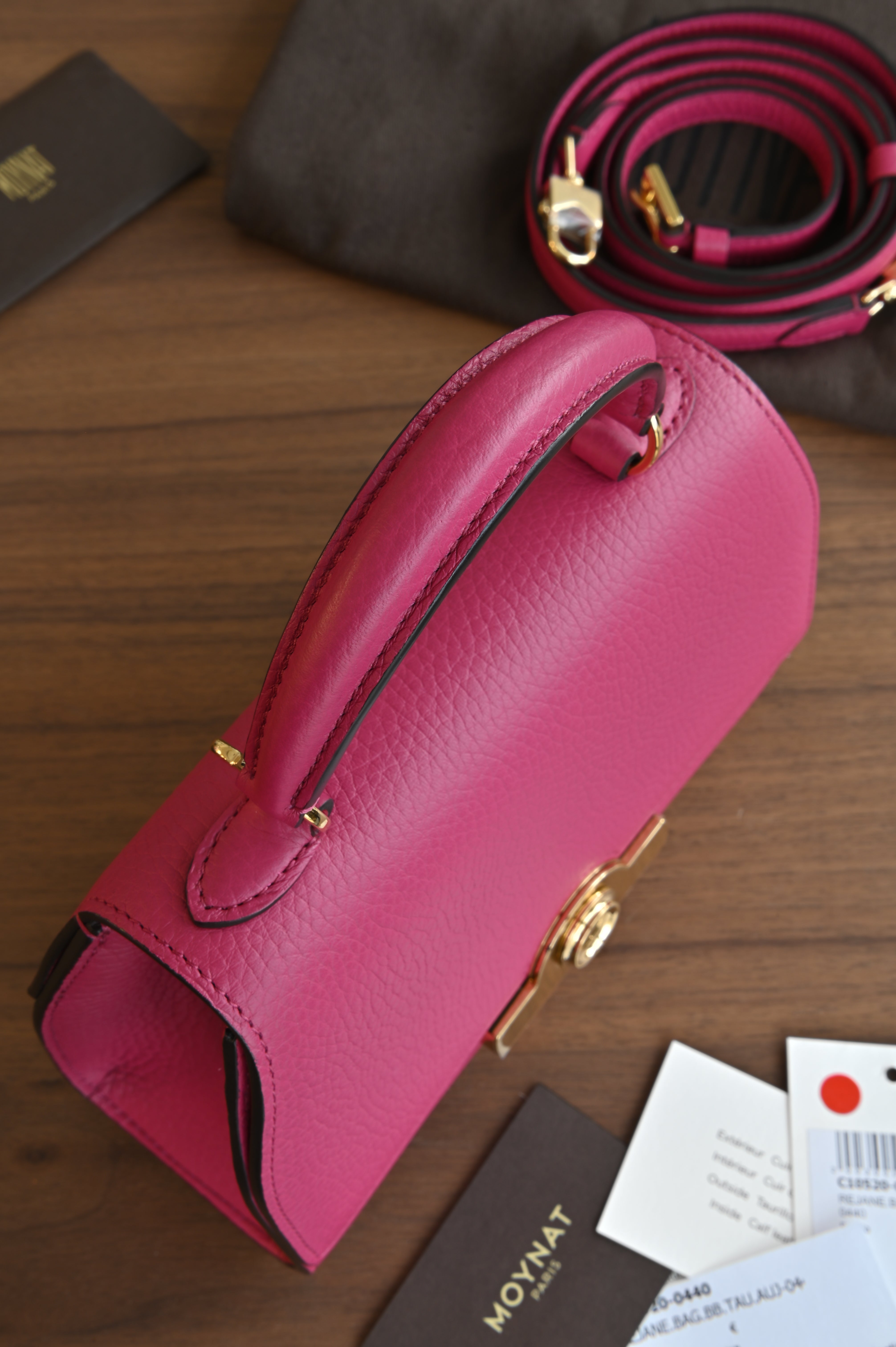 Authentic preloved Moynat Rejane BB in fuchsia pink Taurillon leather – side view