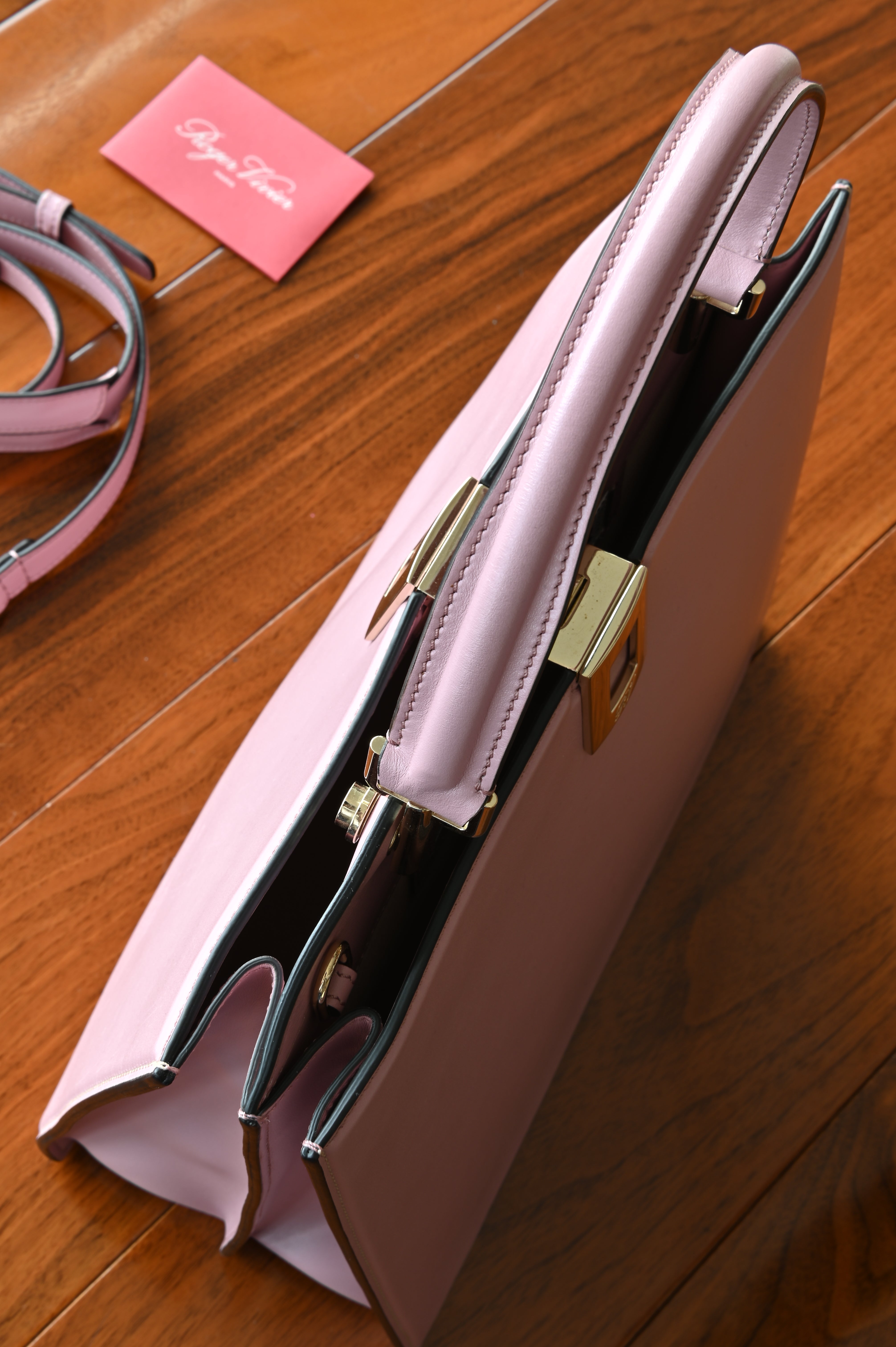 Top view of the Roger Vivier Viv’ Cabas Pink Leather Top Handle Bag highlighting the handle, buckle hardware and interior compartments.