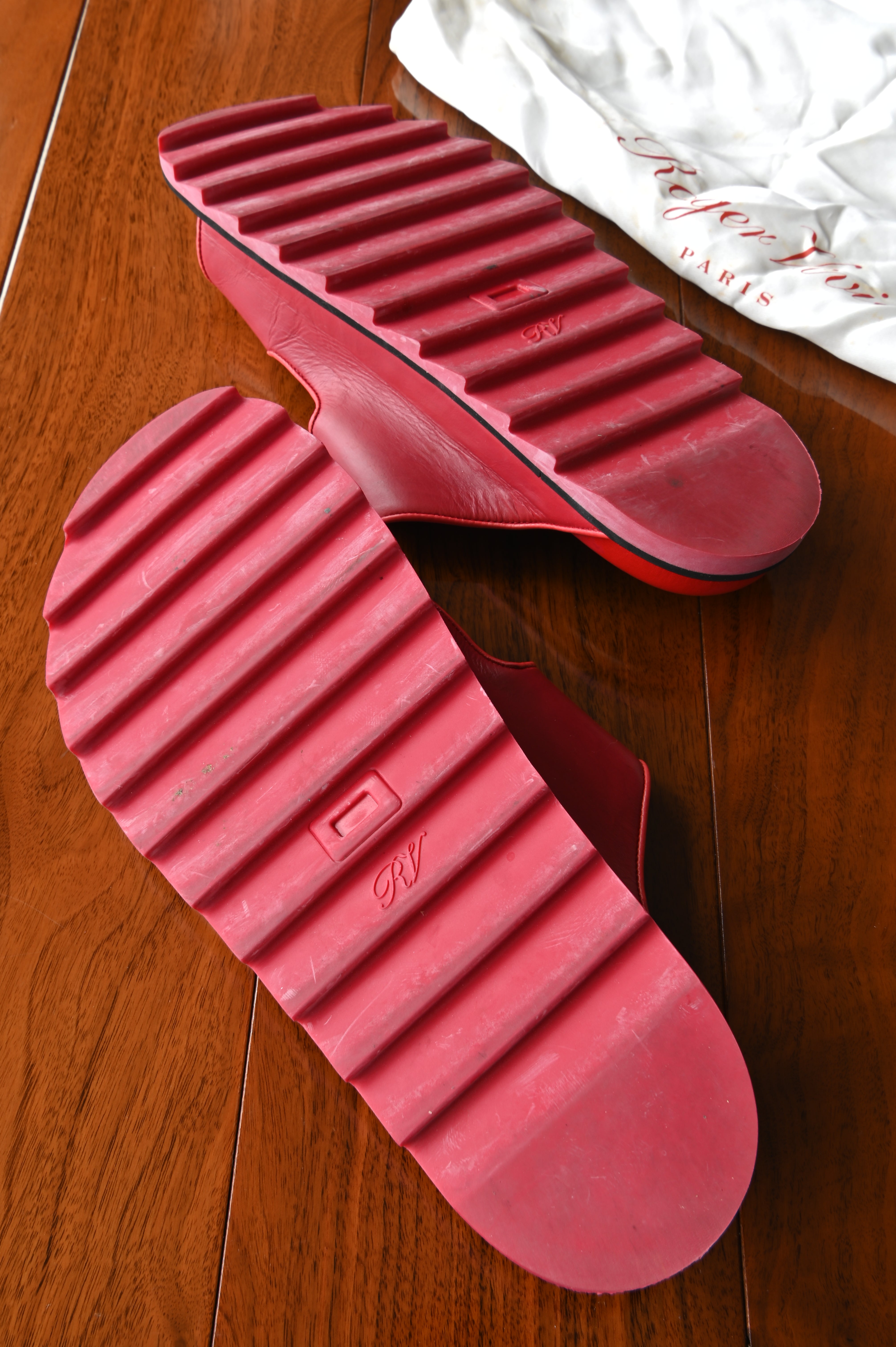Bottom view of authentic Roger Vivier Viv’ Ranger slides showing the distinctive serrated rubber outsoles with normal signs of previous wear.