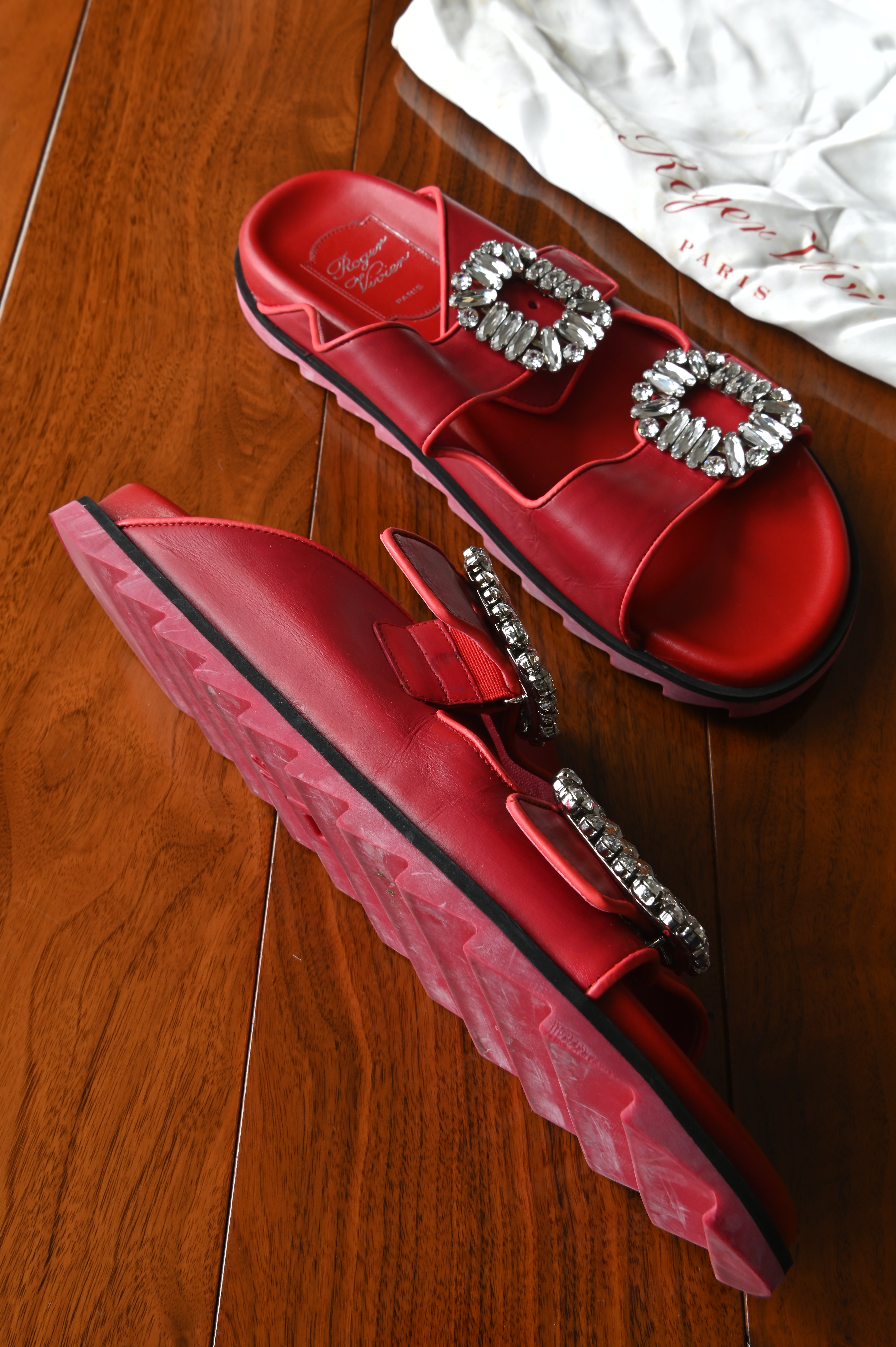 Side profile of Roger Vivier Viv’ Ranger leather slides highlighting the serrated rubber sole and crystal buckle details.