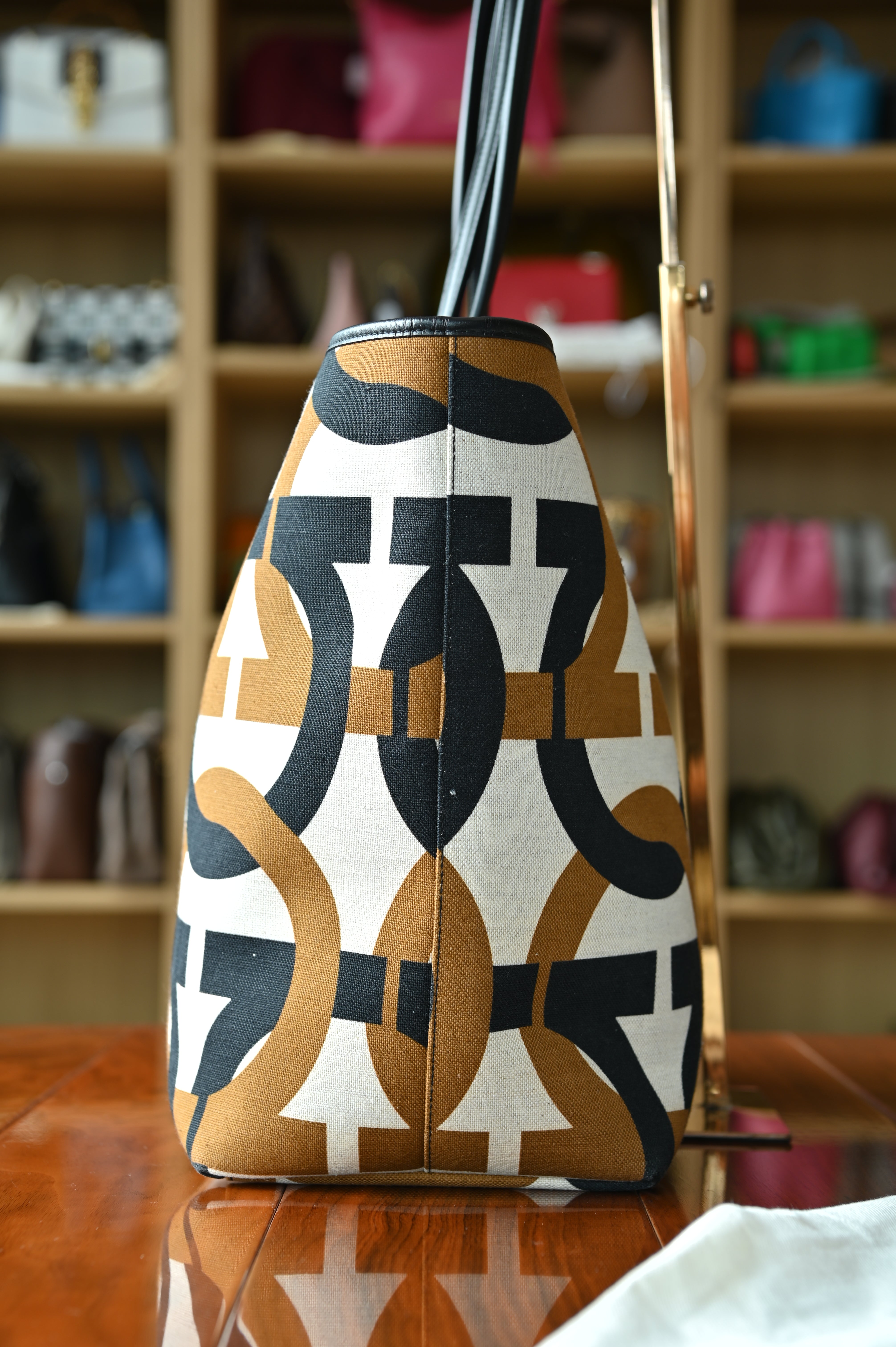 Authentic Salvatore Ferragamo Monogram Canvas Tote Bag showing the left side profile with signature monogram canvas and structured silhouette.