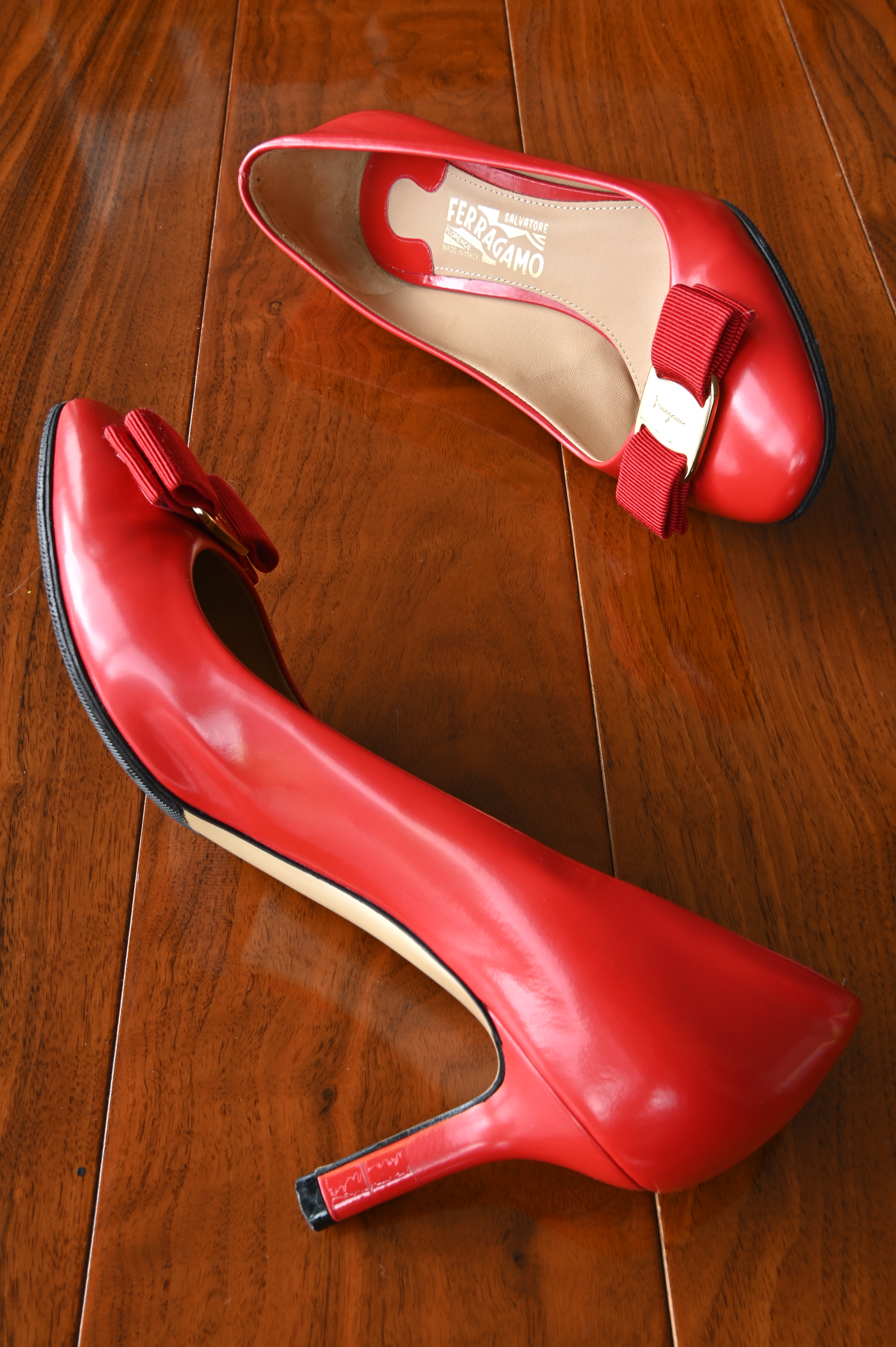 Elegant side view of Salvatore Ferragamo Vara red leather pumps with the classic rounded toe and comfortable heel.