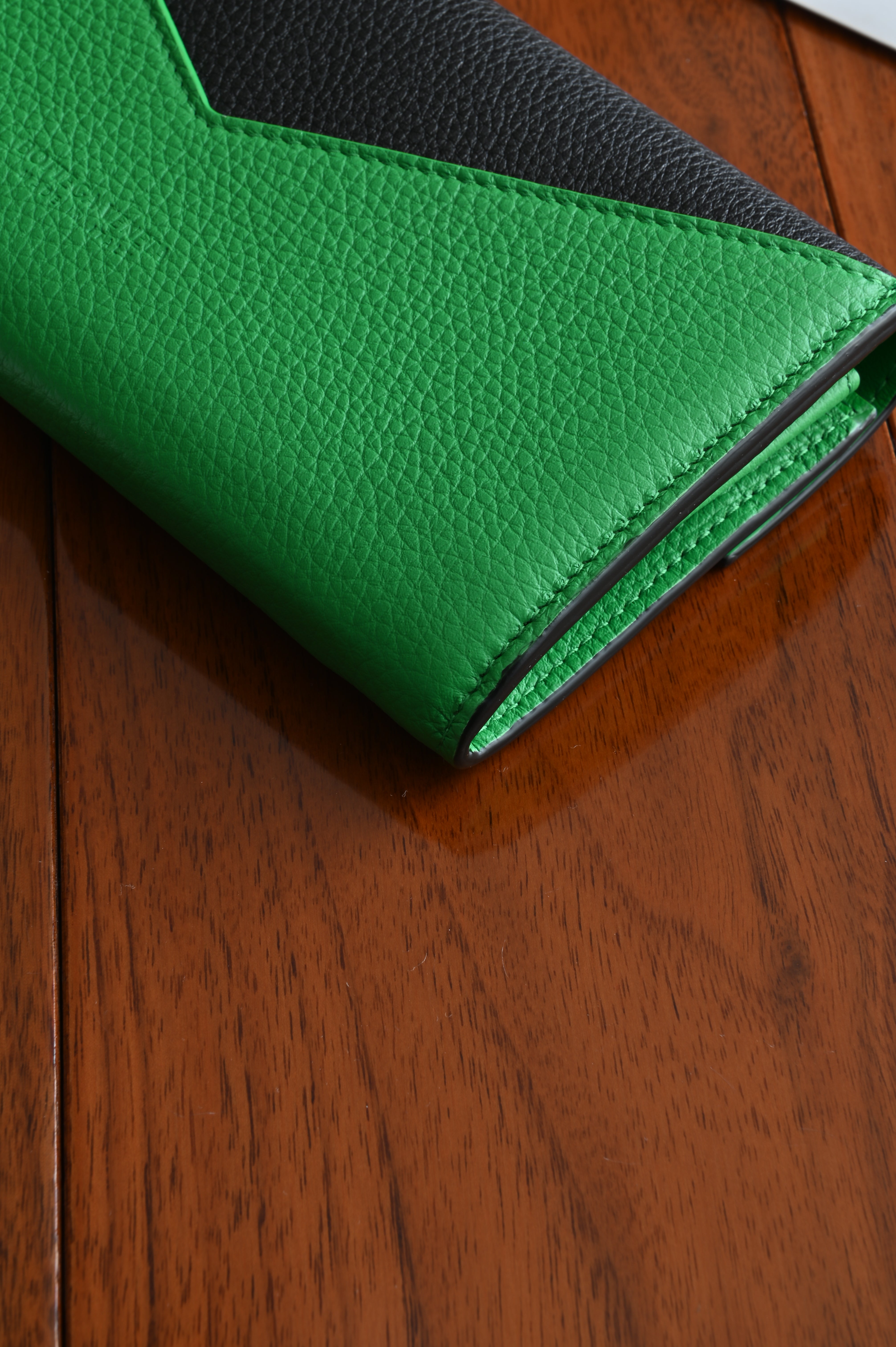 Bottega Veneta long envelope wallet in black and parakeet green back corner two