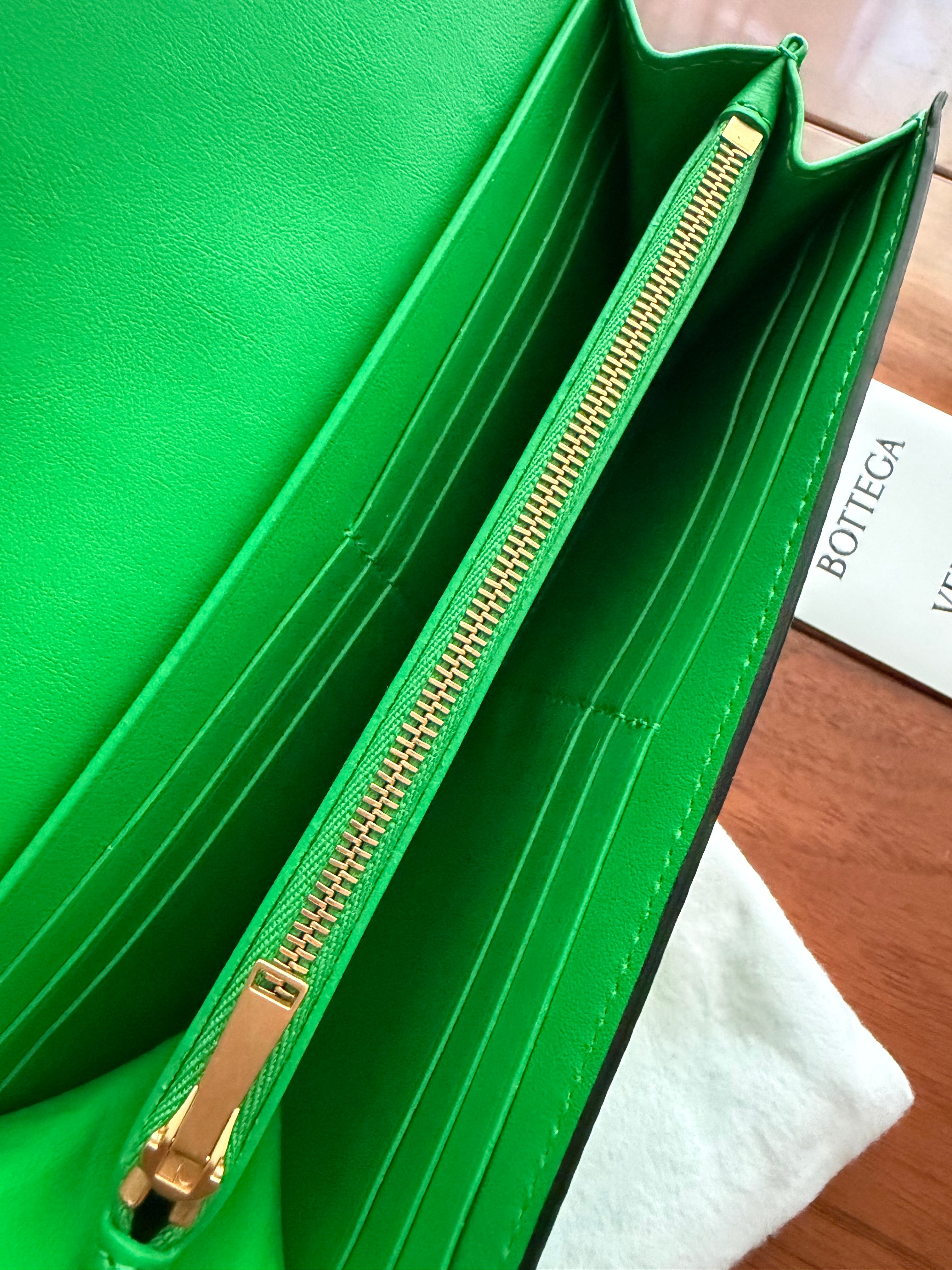 Bottega Veneta long envelope wallet in black and parakeet green inside