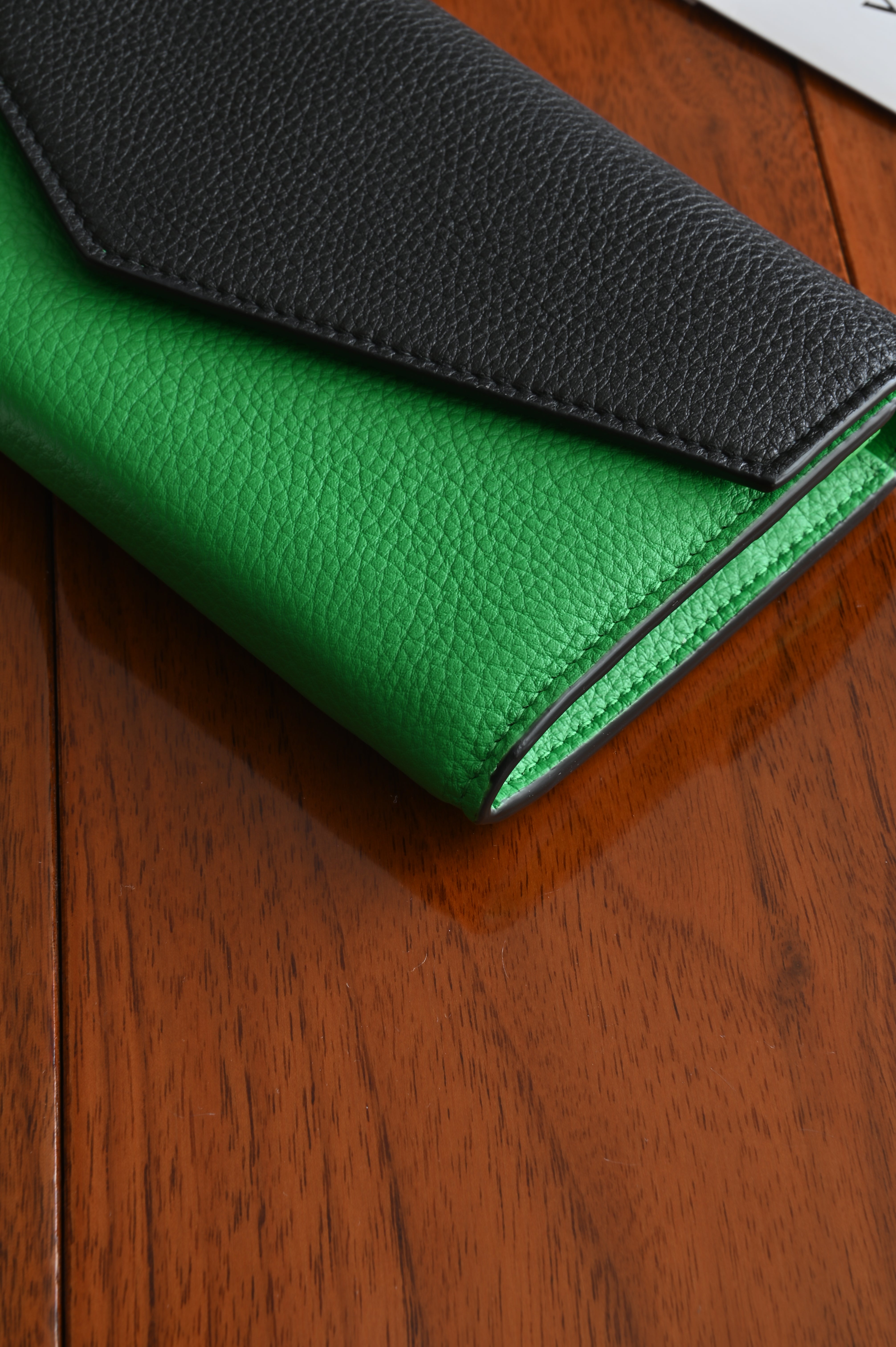 Bottega Veneta long envelope wallet in black and parakeet green right