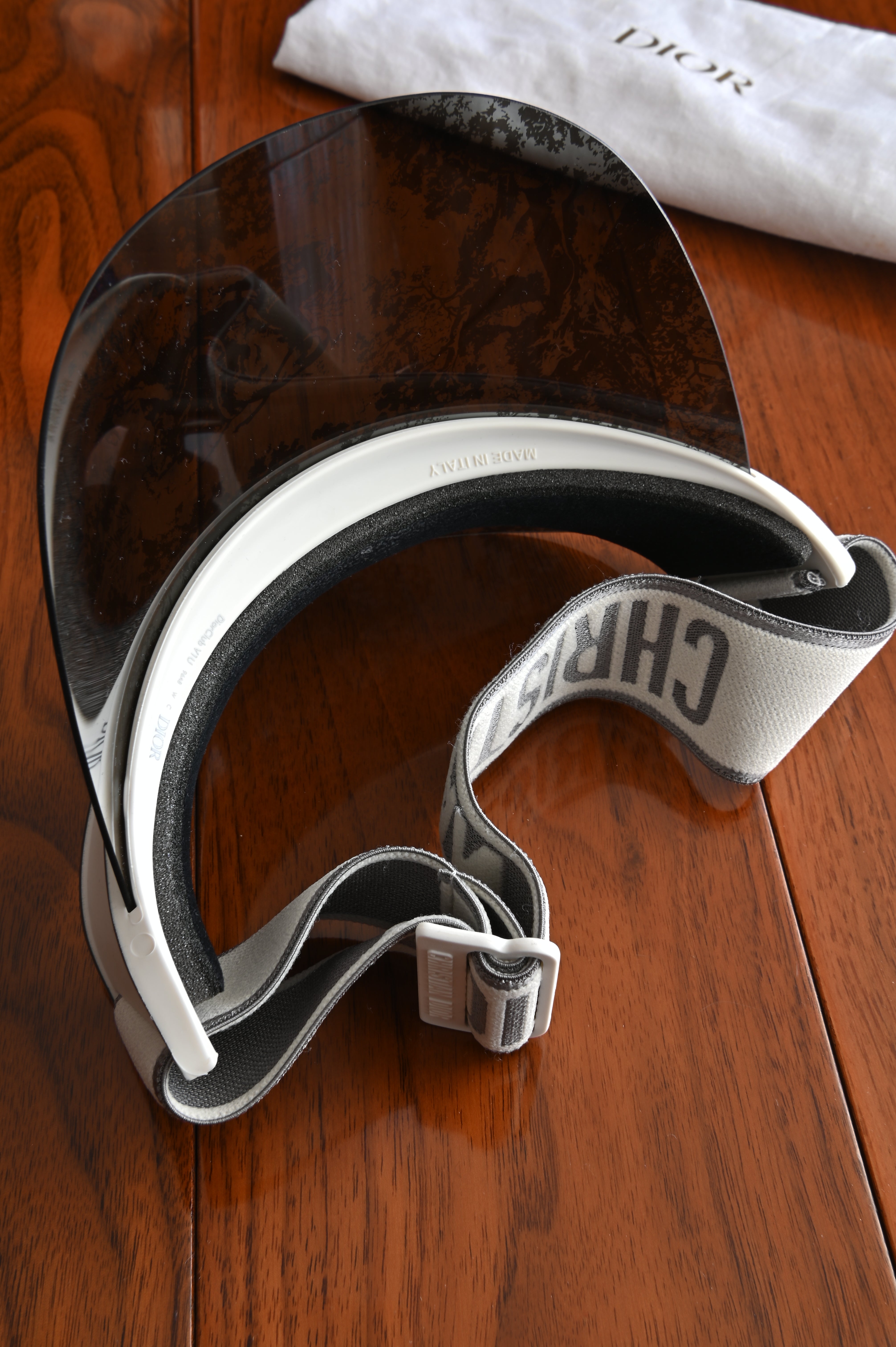 Christian Dior DiorClub V1U visor with a black and silver patterned brim folded