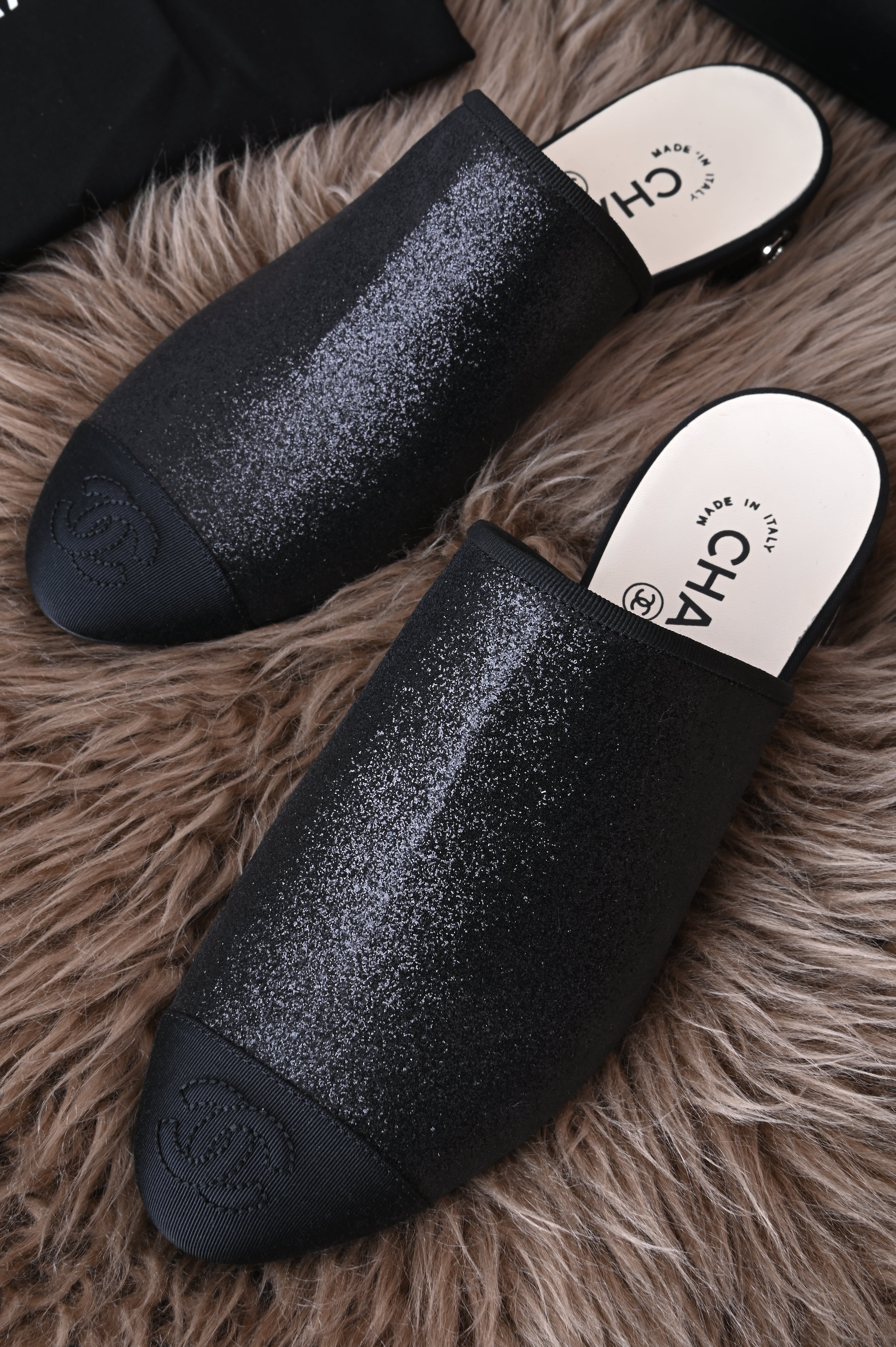 Chanel mules in glittery black