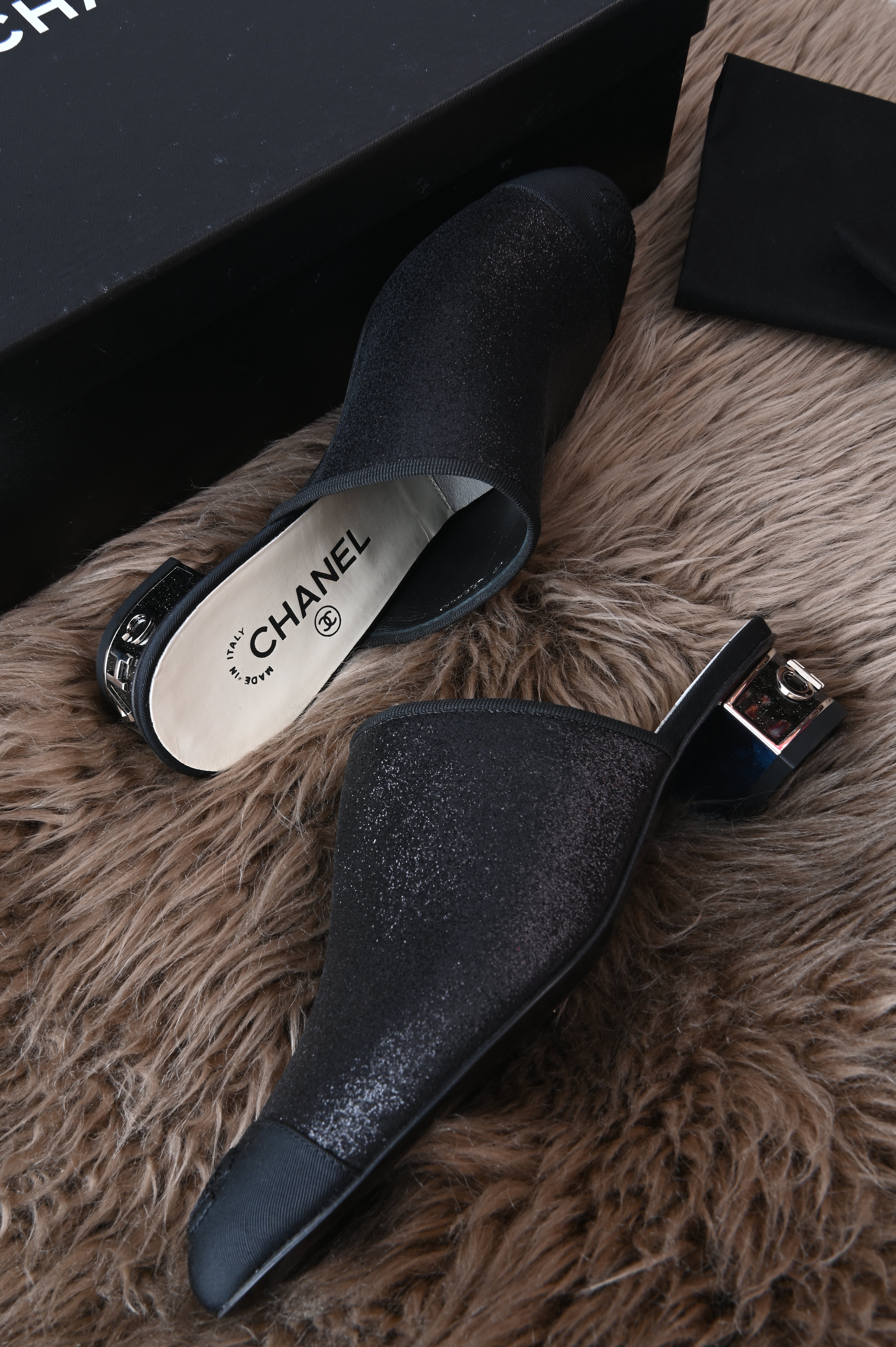 Chanel mules in glittery black