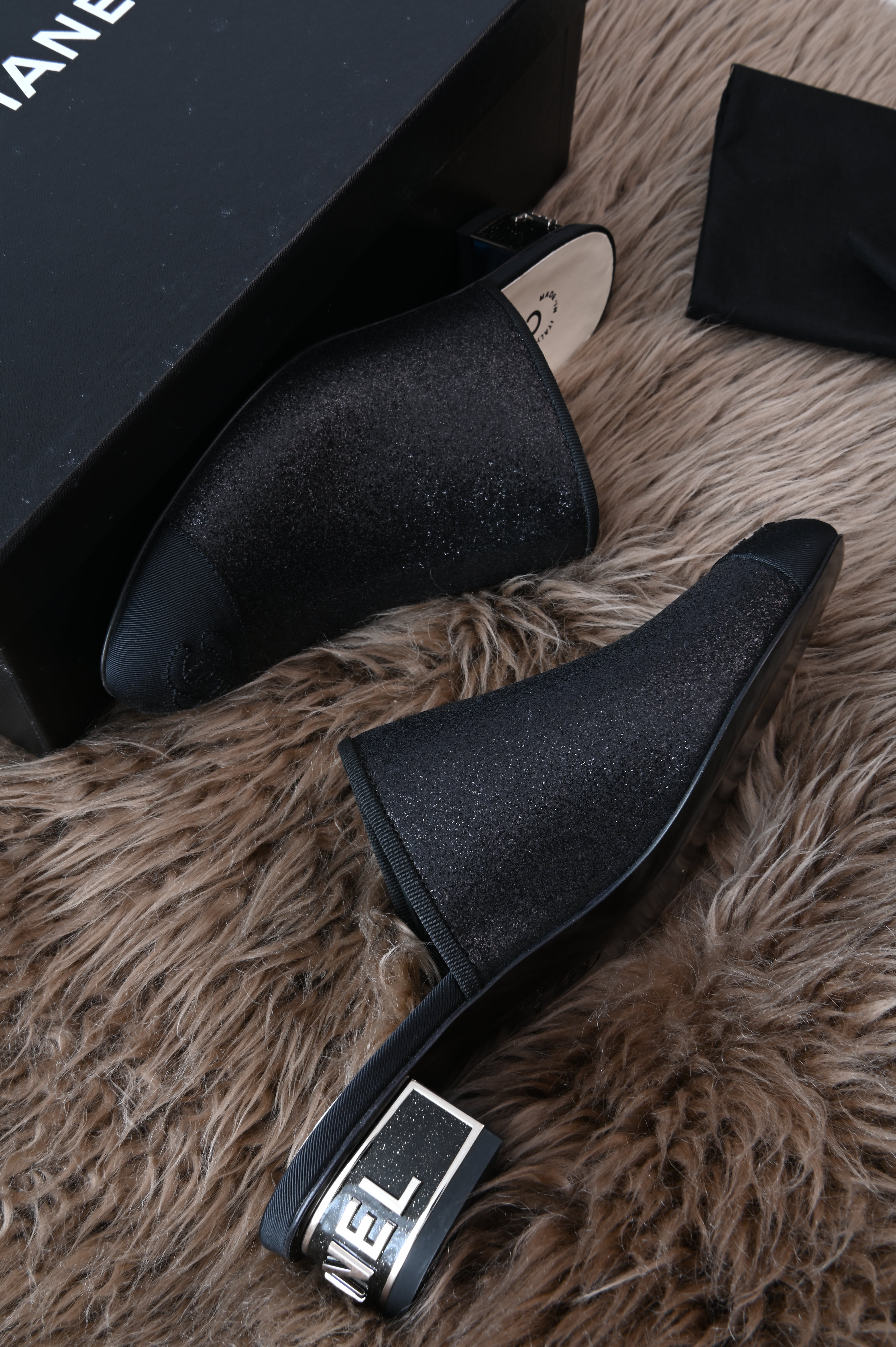 Chanel mules in glittery black