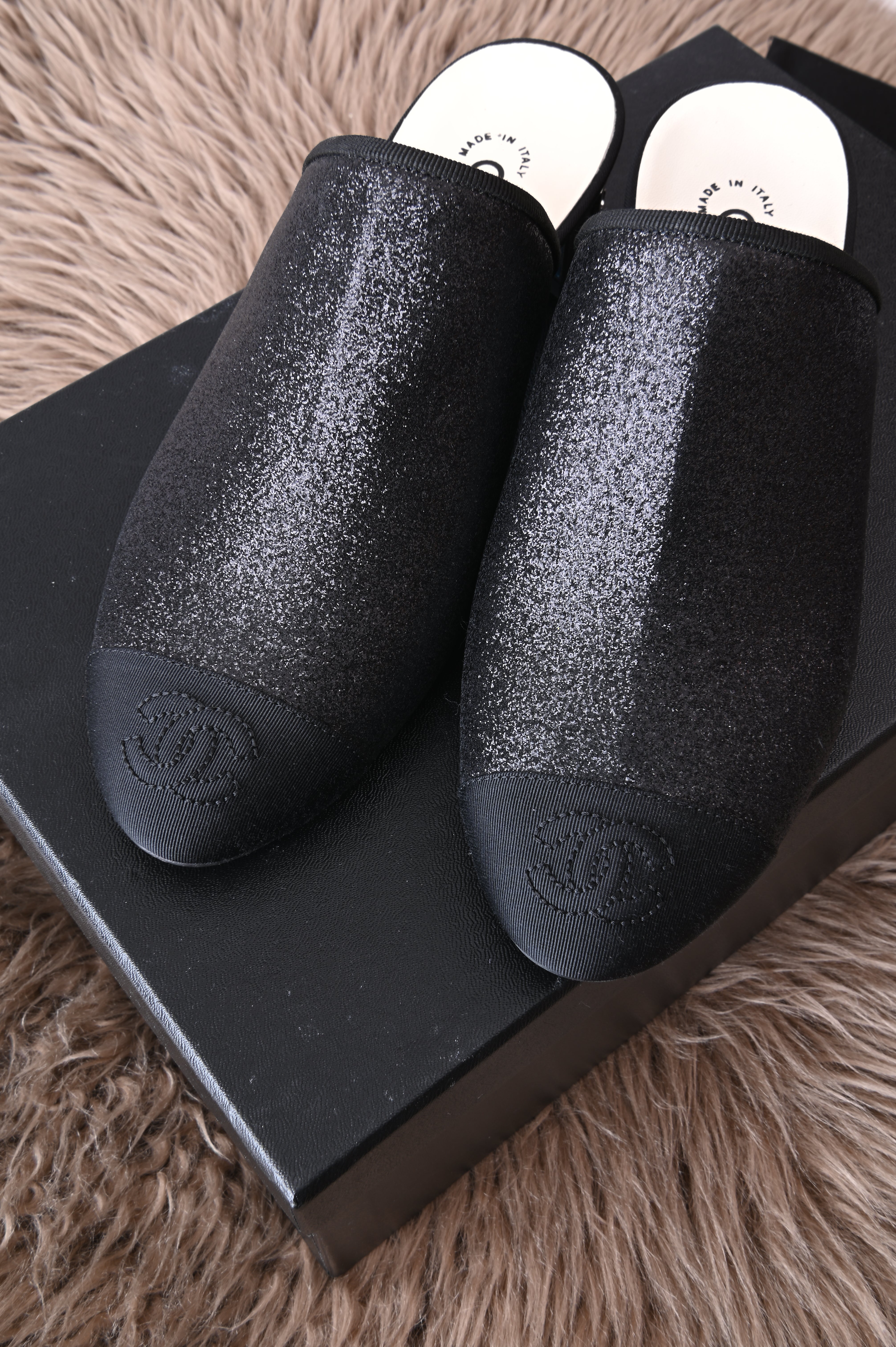 Chanel mules in glittery black