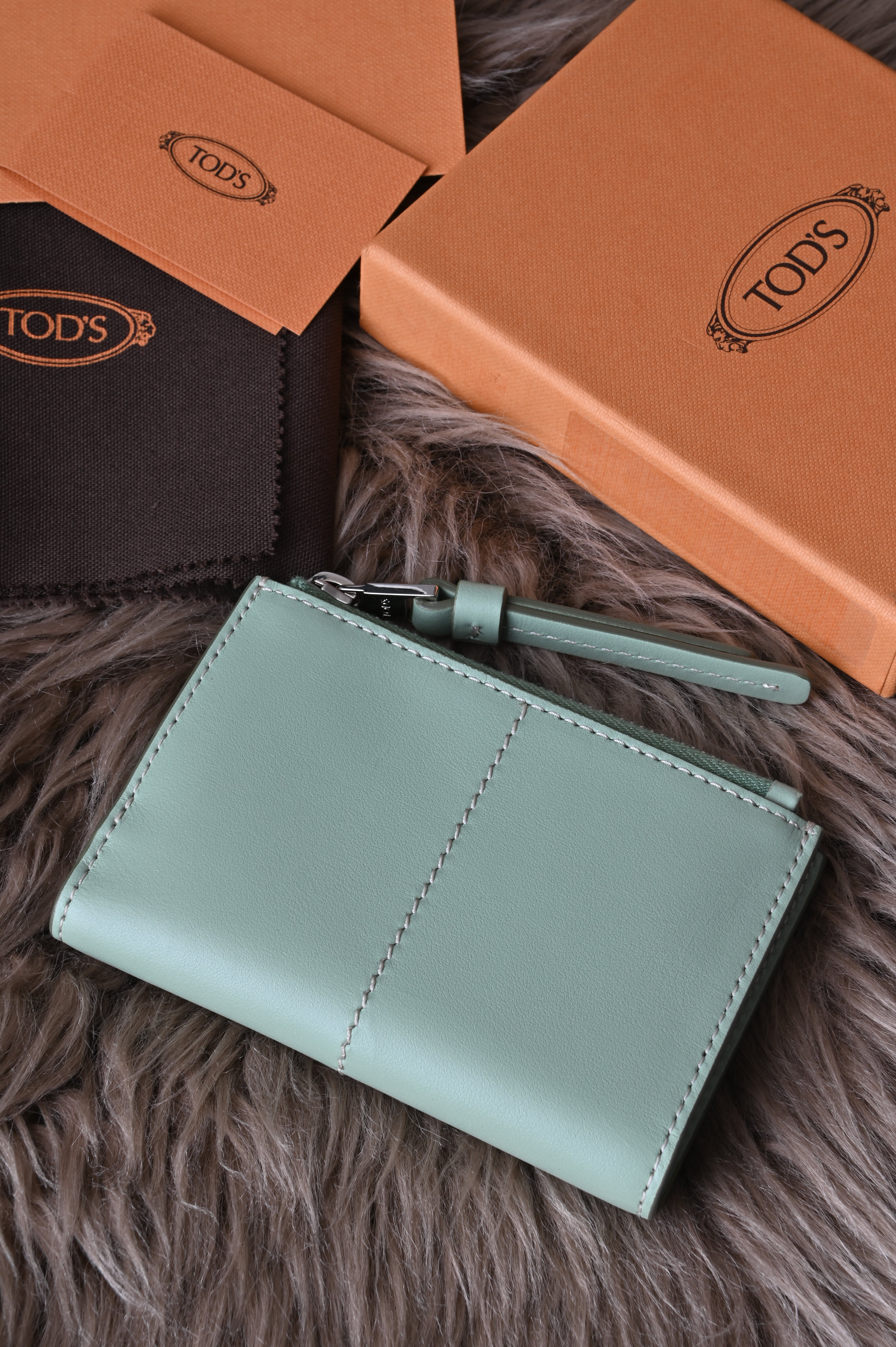 Tod's Flap compact wallet in teal green