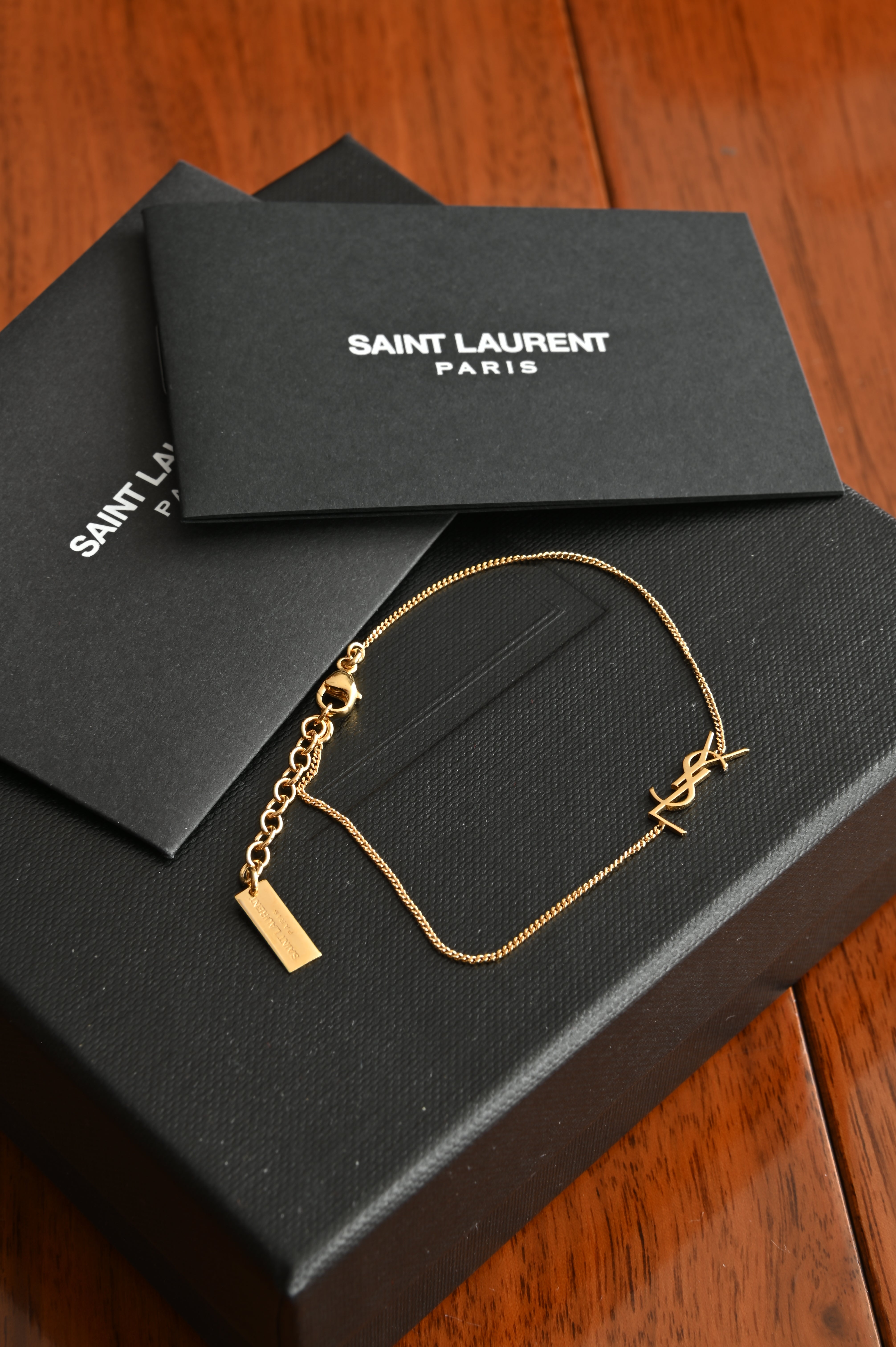 Saint Laurent Cassandre bracelet in gold brass and crystal.