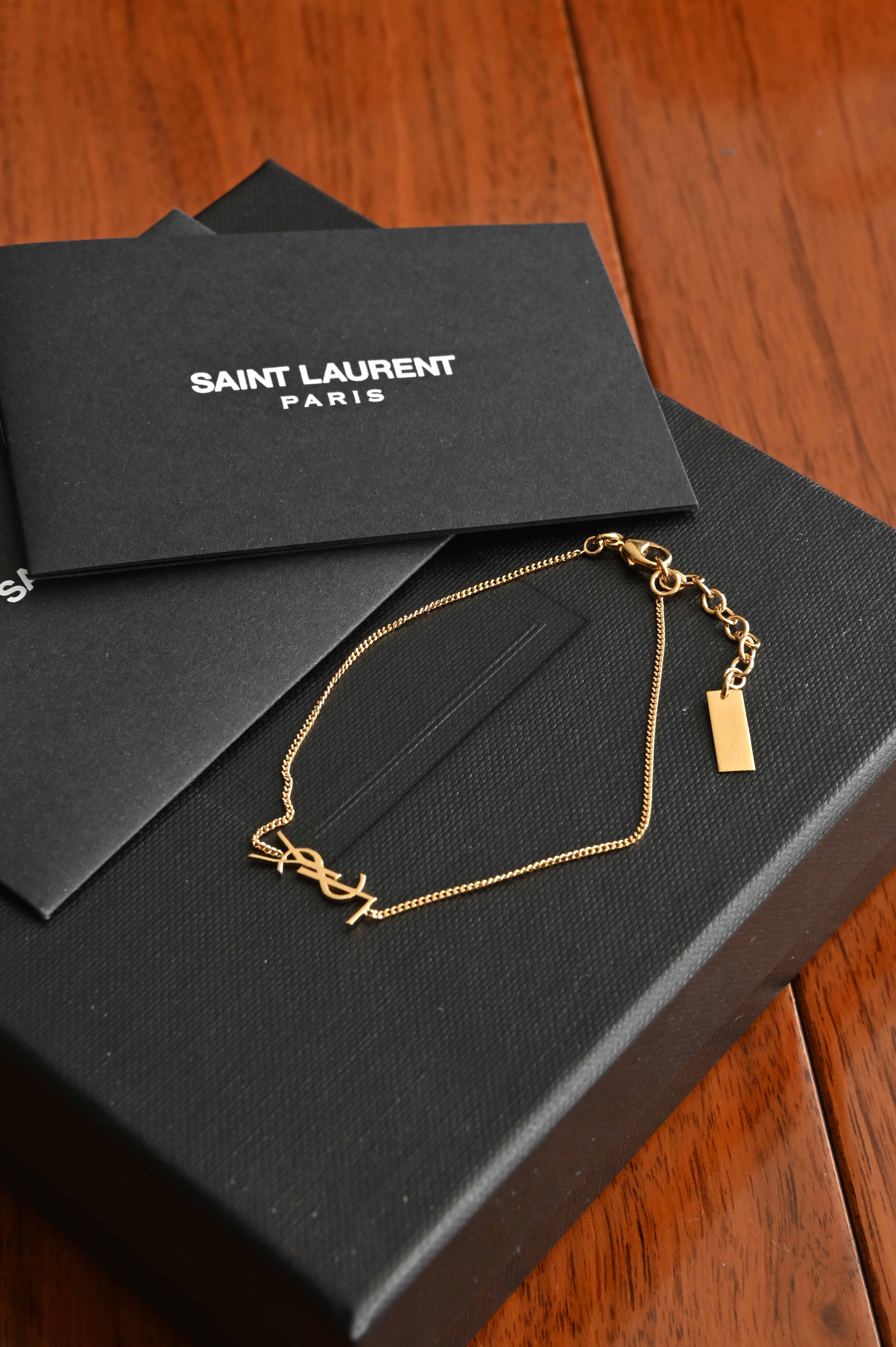 Saint Laurent Cassandre bracelet in gold brass and crystal.
