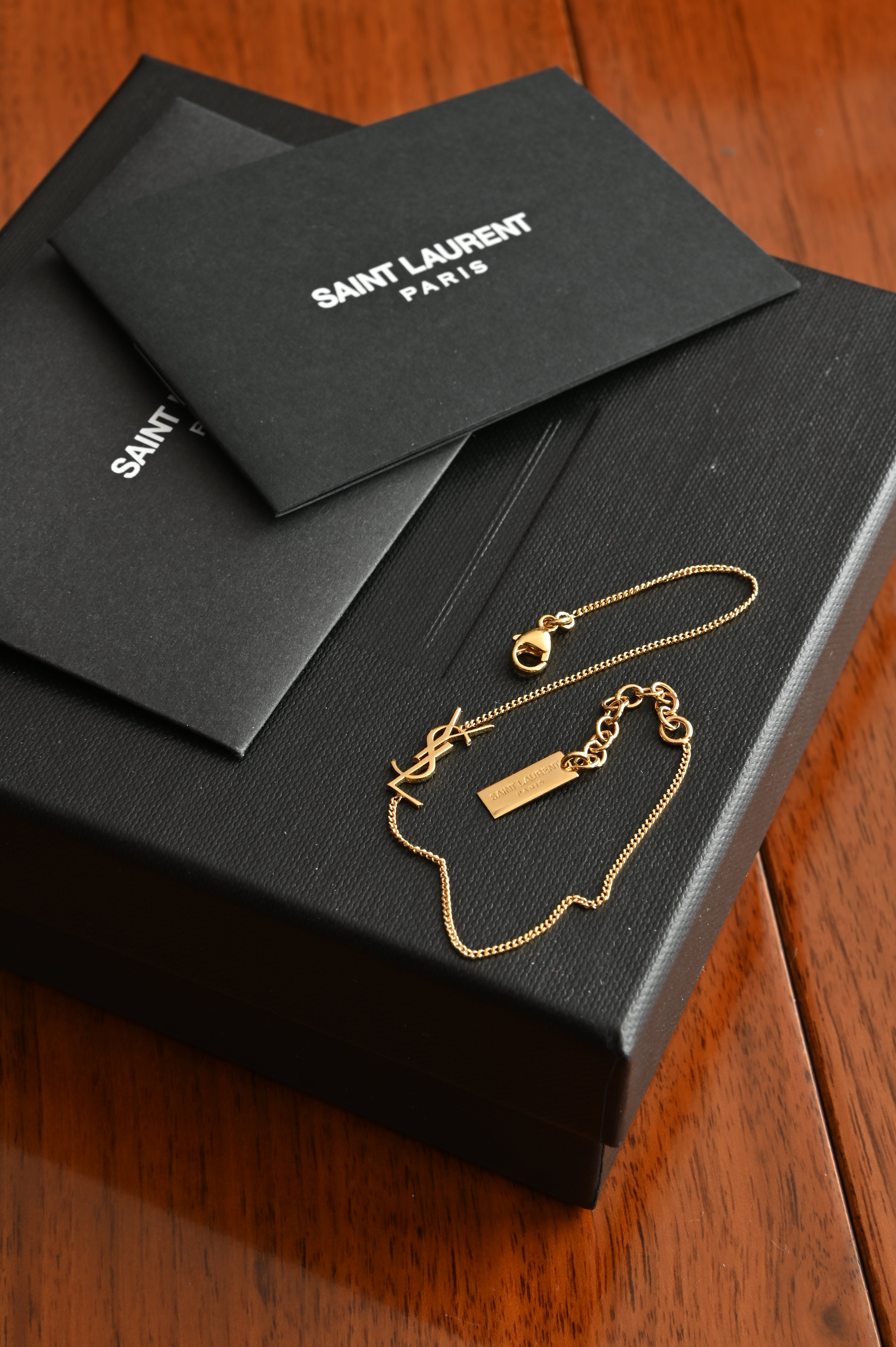 Saint Laurent Cassandre bracelet in gold brass and crystal.