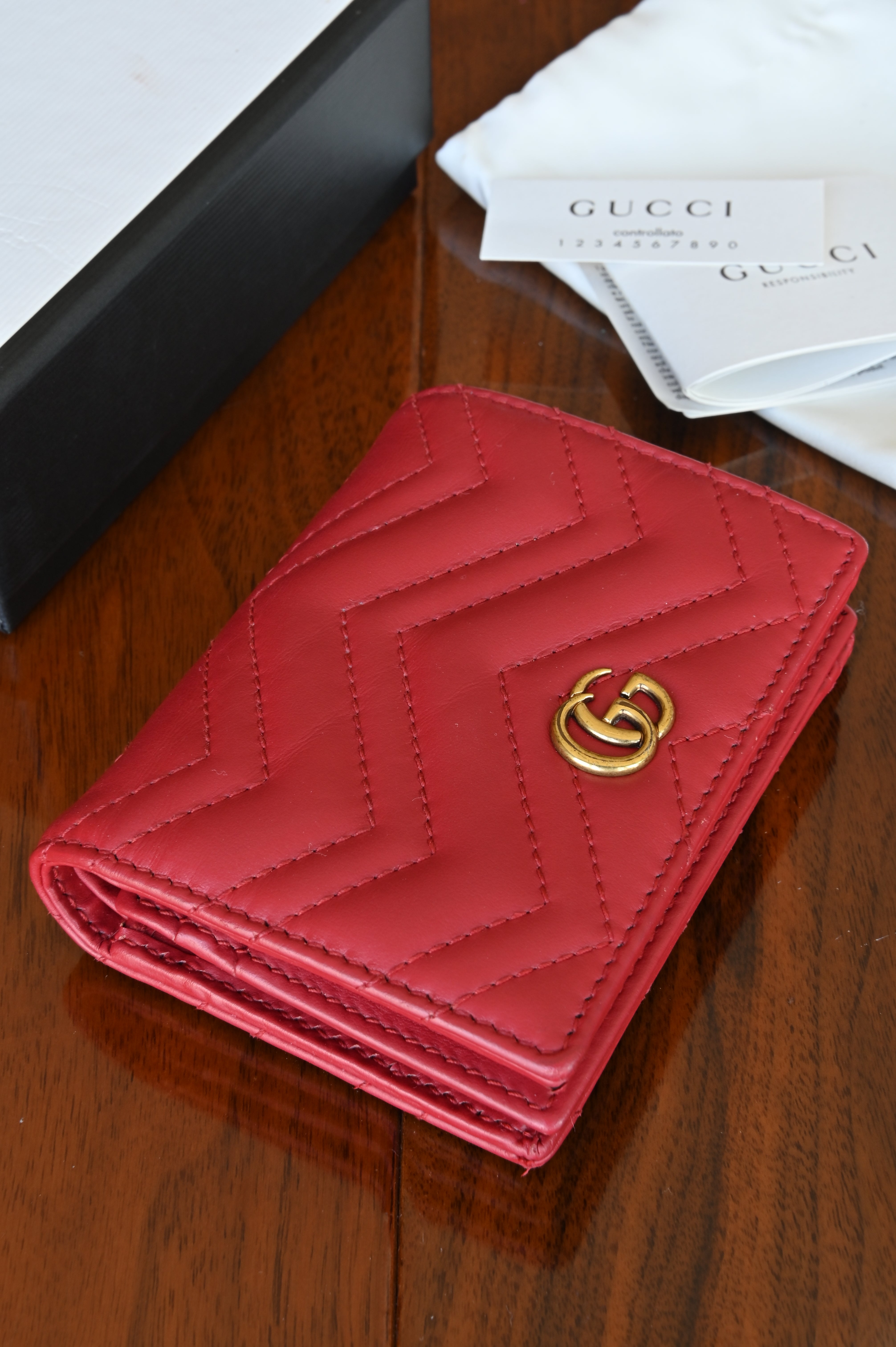 Gucci Red Quilted Compact Wallet in Gold front