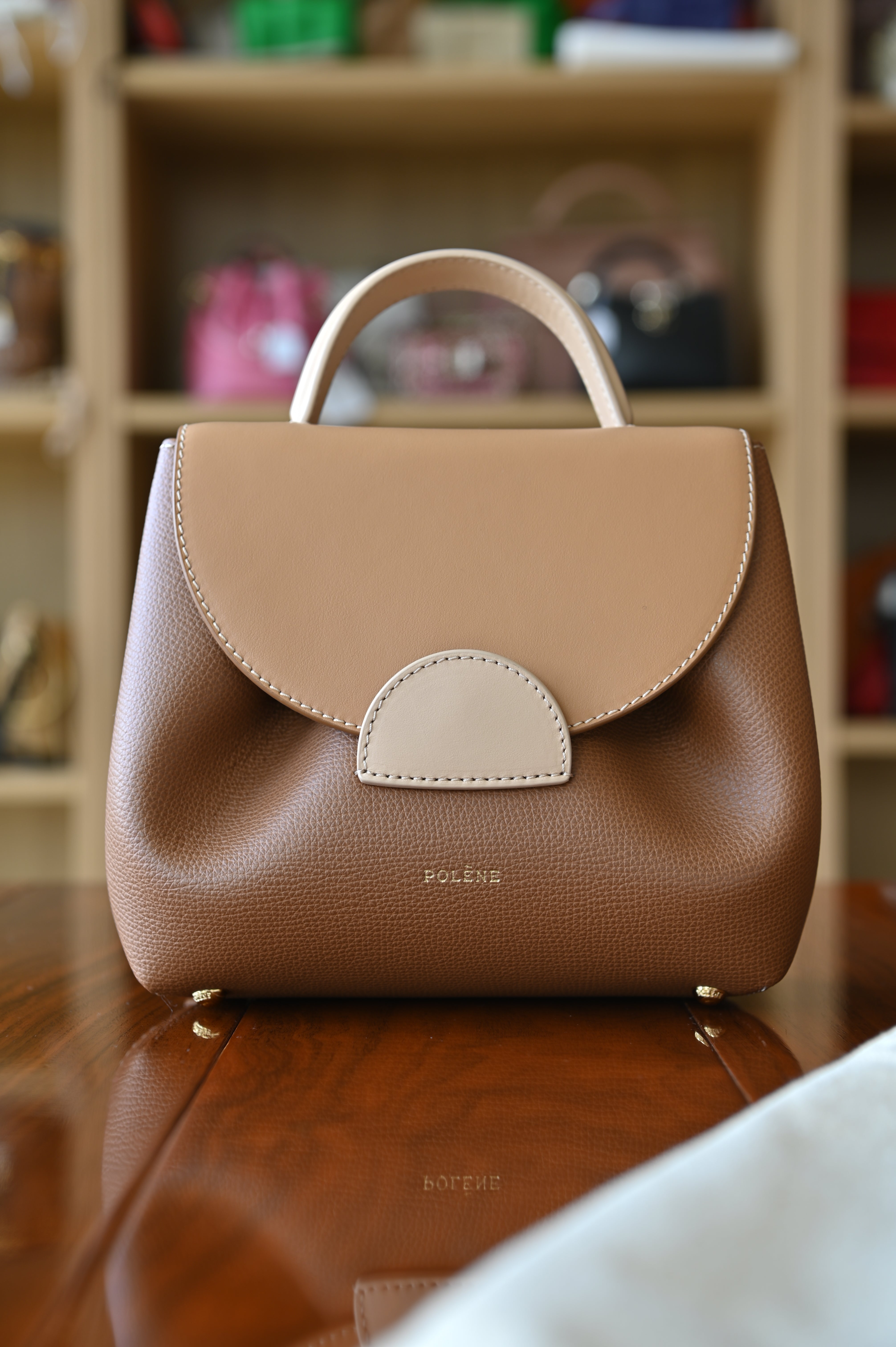 Authentic preloved Polène Numéro Un Nano Bag in Trio Camel featuring a sculpted leather silhouette, curved flap design, and signature gold-tone hardware.