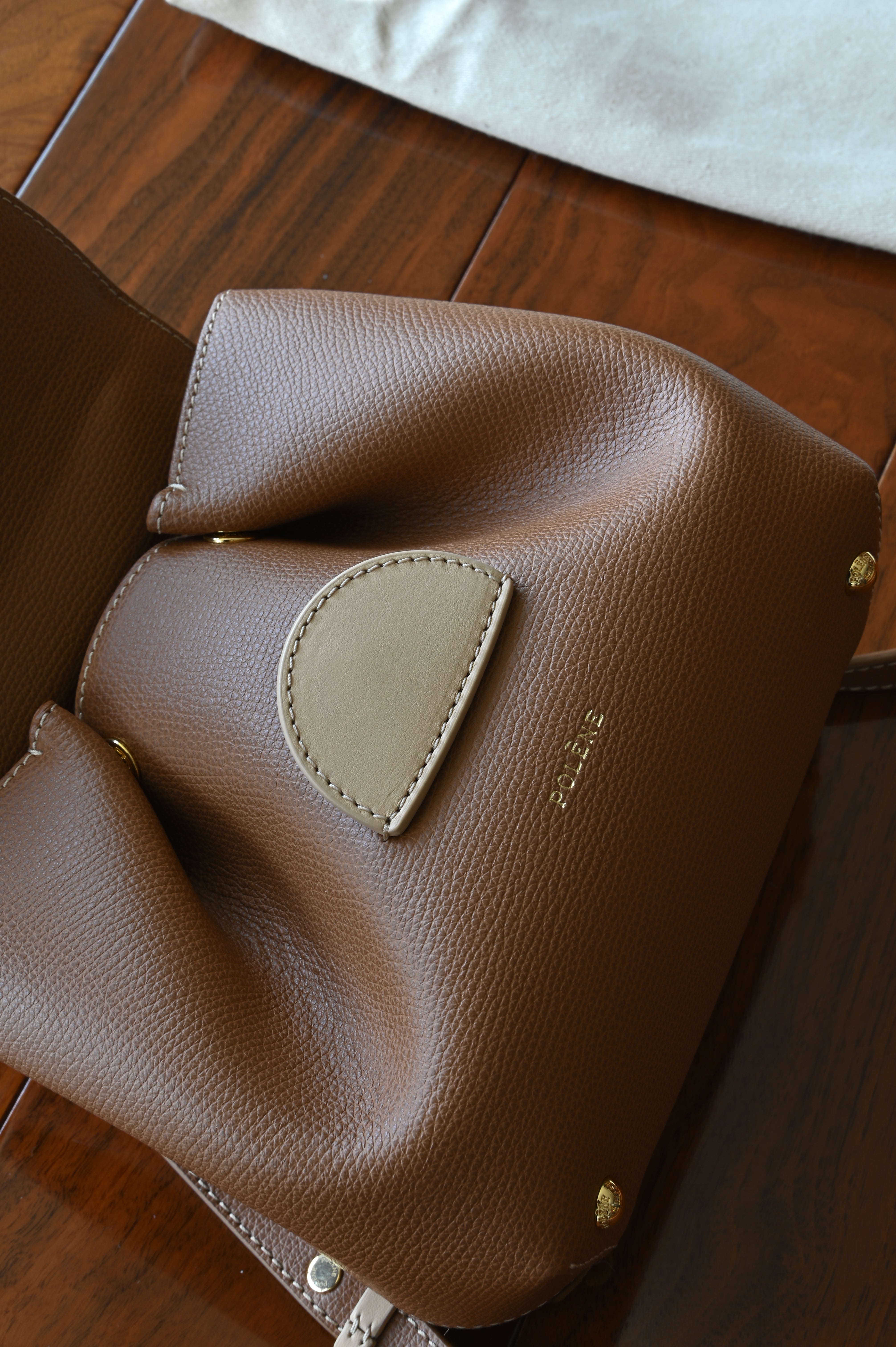 Authentic preloved Polène Numéro Un Nano Bag in Trio Camel, detailed view showcasing the signature curved silhouette, refined craftsmanship, and premium leather construction.