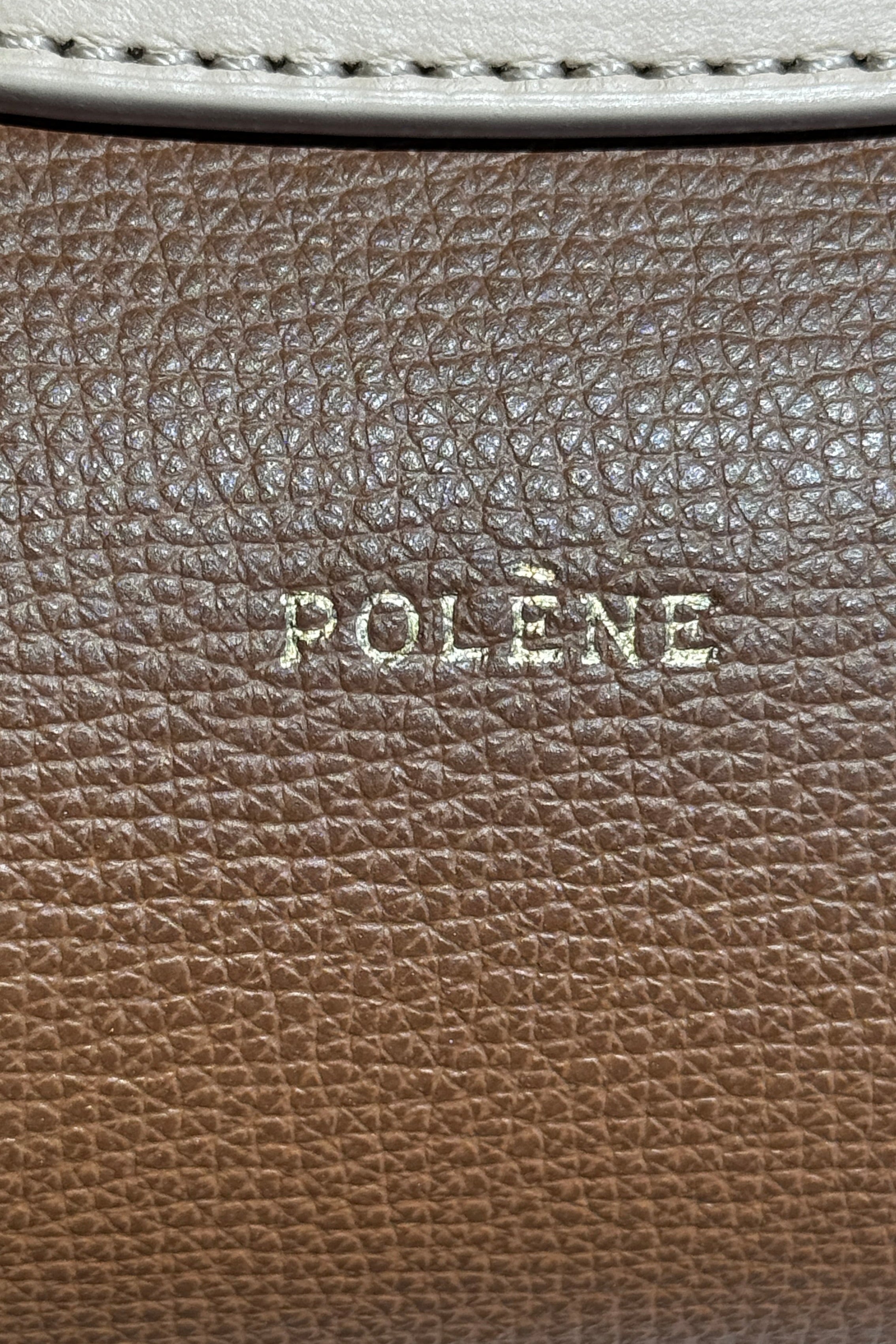 Authentic preloved Polène Numéro Un Nano Bag in Trio Camel, close-up logo detail showcasing the embossed Polène branding and premium leather craftsmanship.