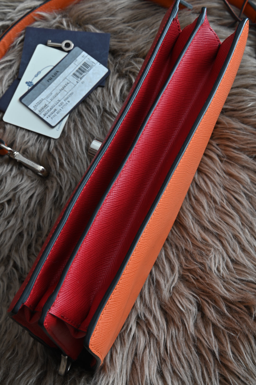 Prada two-way clutch bag Saffiano Lux in Fuoco Papaya bottom