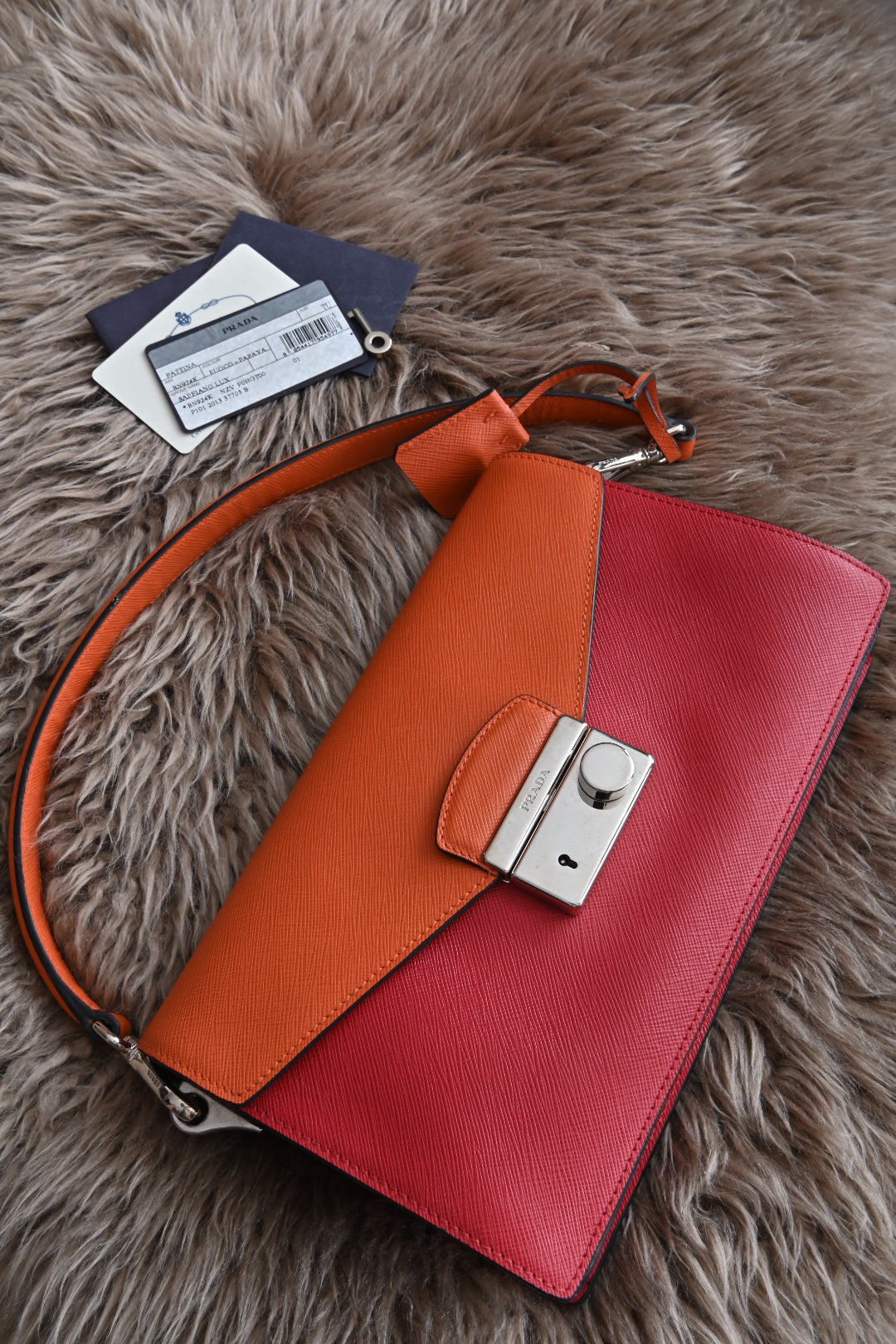 Prada two-way clutch bag Saffiano Lux in Fuoco Papaya front