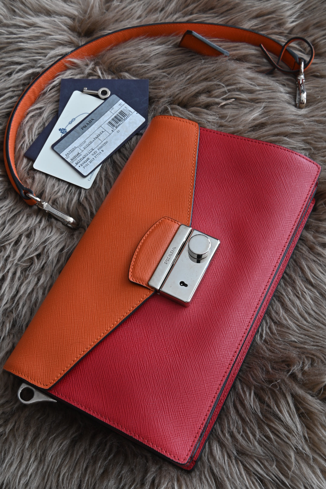 Prada two-way clutch bag Saffiano Lux in Fuoco Papaya front two