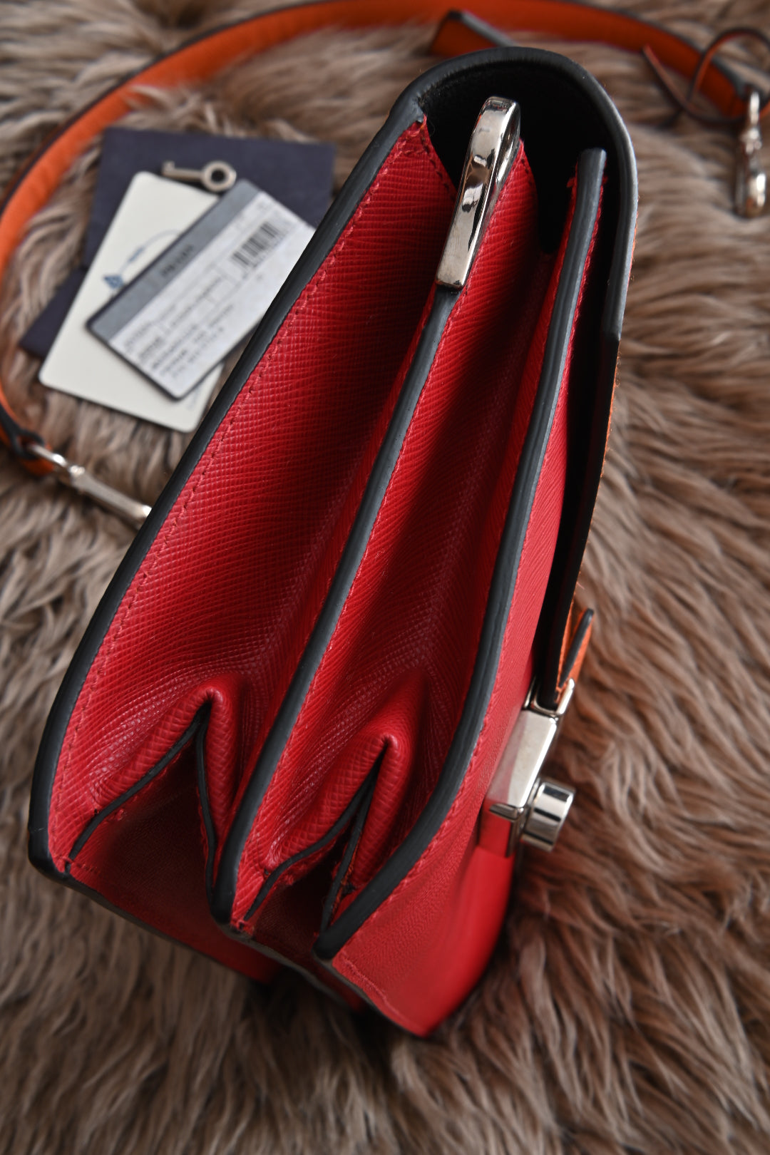 Prada two-way clutch bag Saffiano Lux in Fuoco Papaya left