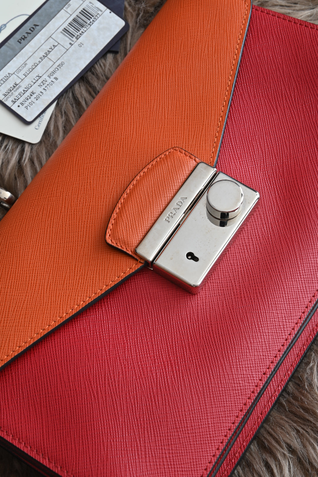 Prada two-way clutch bag Saffiano Lux in Fuoco Papaya lock