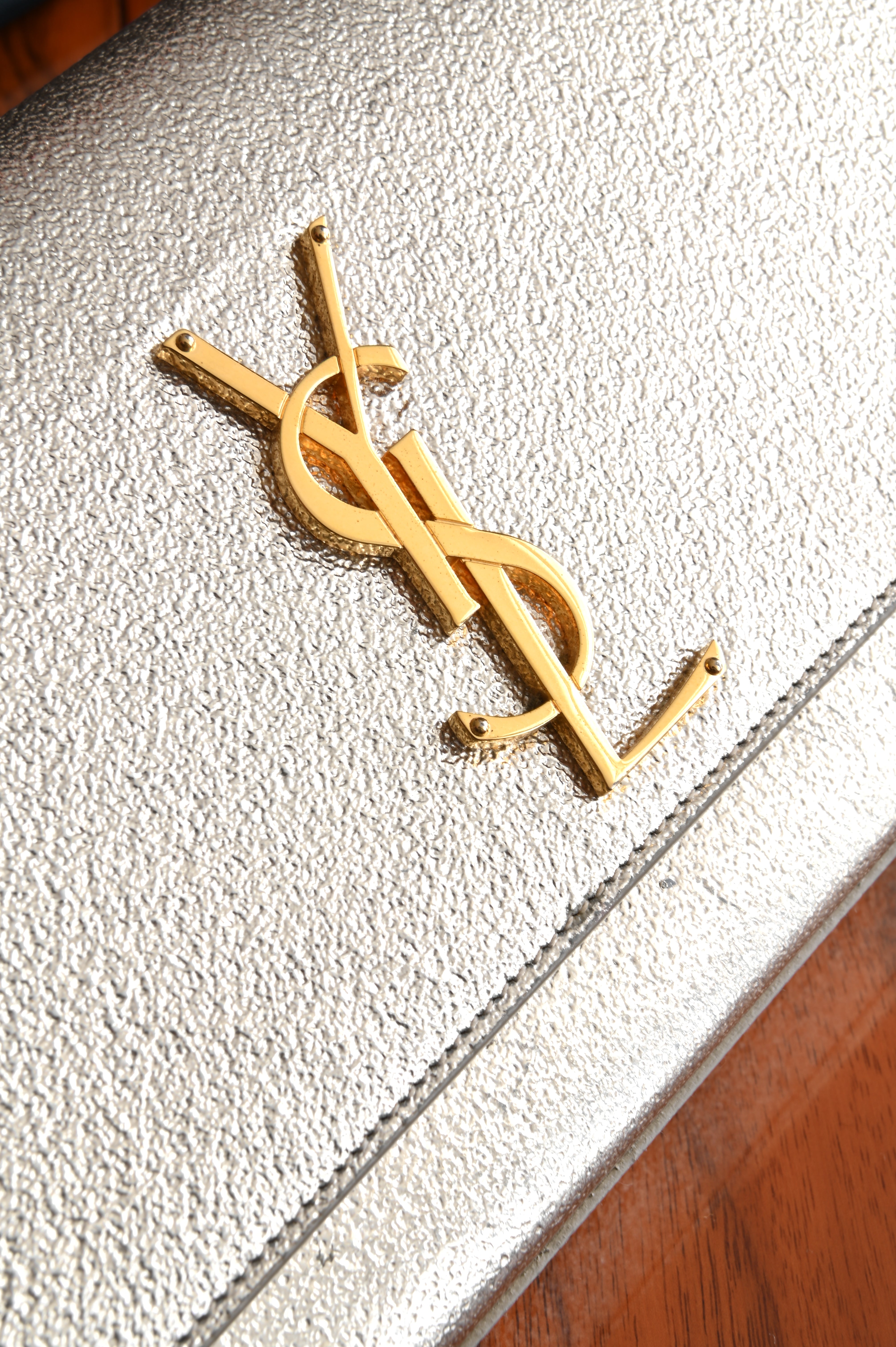 Saint Laurent Metallic Gold clutch logo